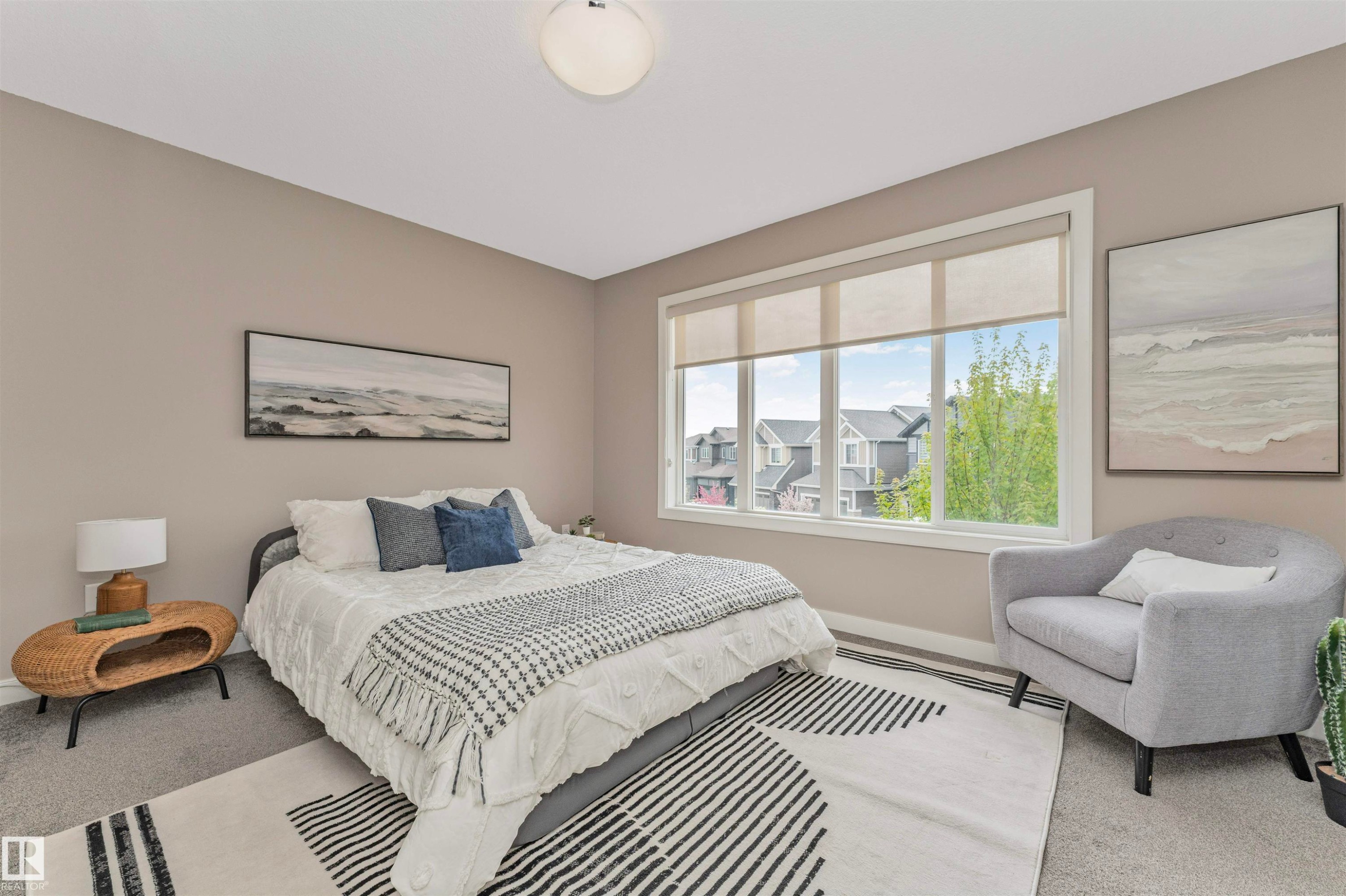 Spacious room featuring neutral-toned walls, a large window with roller shades, and plush carpeting - 22124 85 Avenue Nw, Edmonton, AB - Indoor Photo Showing Bedroom
