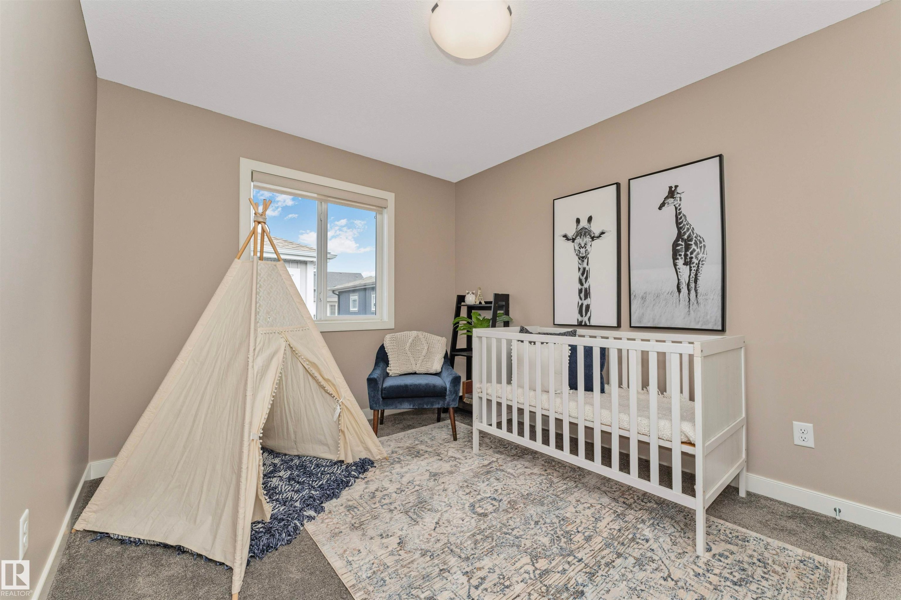 Neutral tone walls, carpeted flooring, a ceiling-mounted light fixture, a window with white trim, and white baseboards - 22124 85 Avenue Nw, Edmonton, AB - Indoor Photo Showing Bedroom
