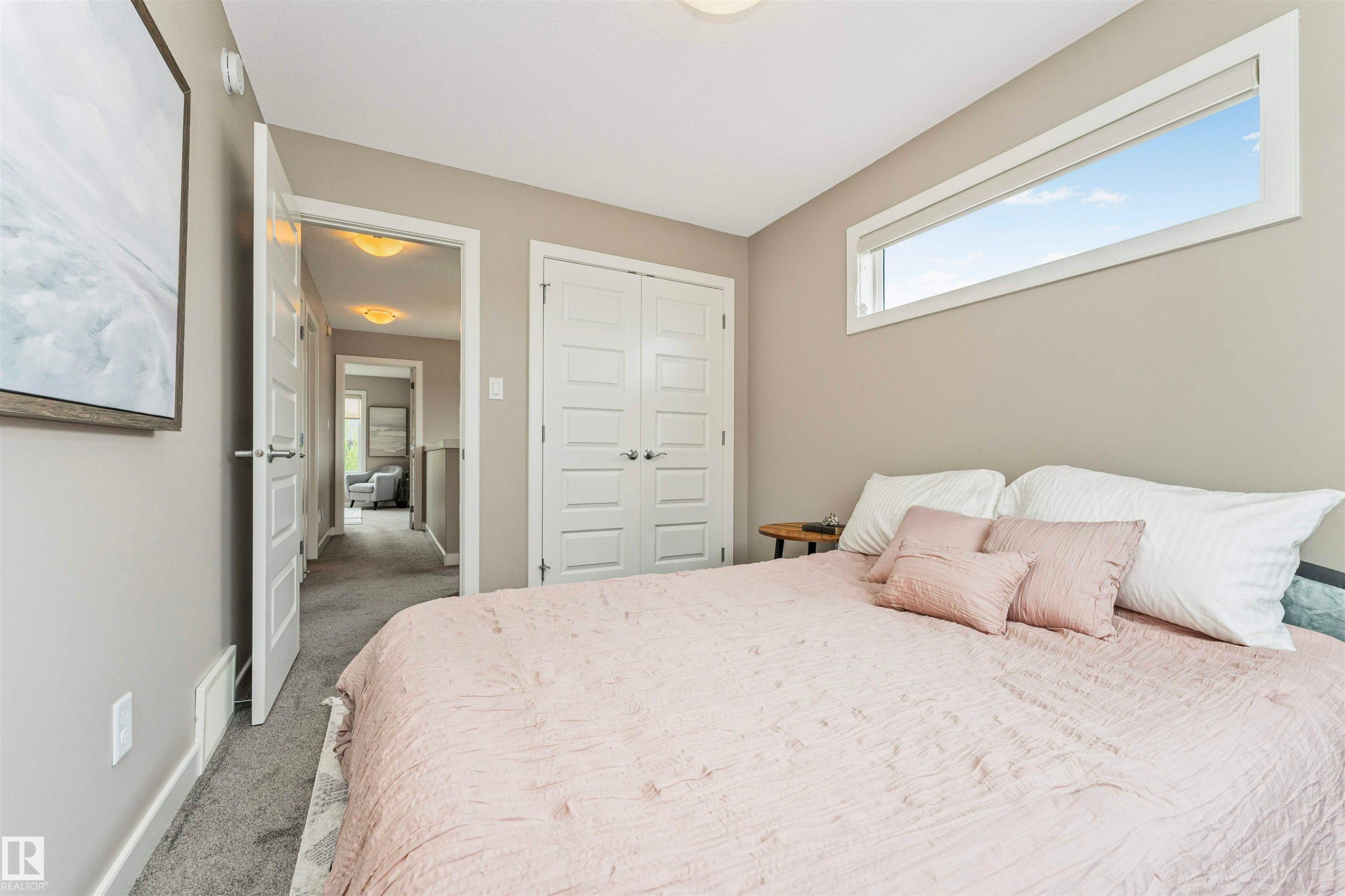 Bedroom featuring a high horizontal window, neutral wall paint, and gray carpet - 22124 85 Avenue Nw, Edmonton, AB - Indoor Photo Showing Bedroom