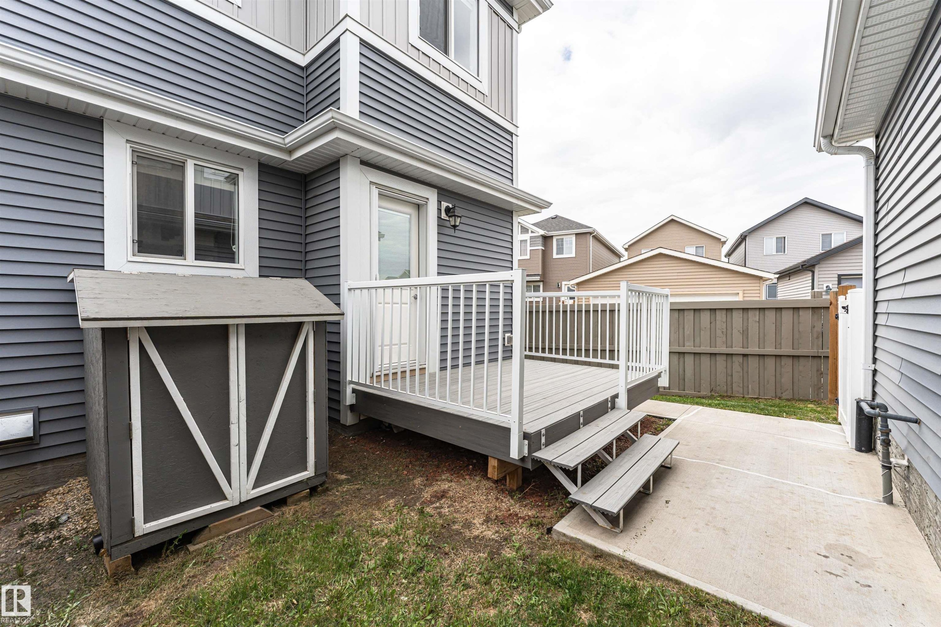 Private exterior deck with composite decking and white railings - 22124 85 Avenue Nw, Edmonton, AB - Outdoor With Deck Patio Veranda With Exterior