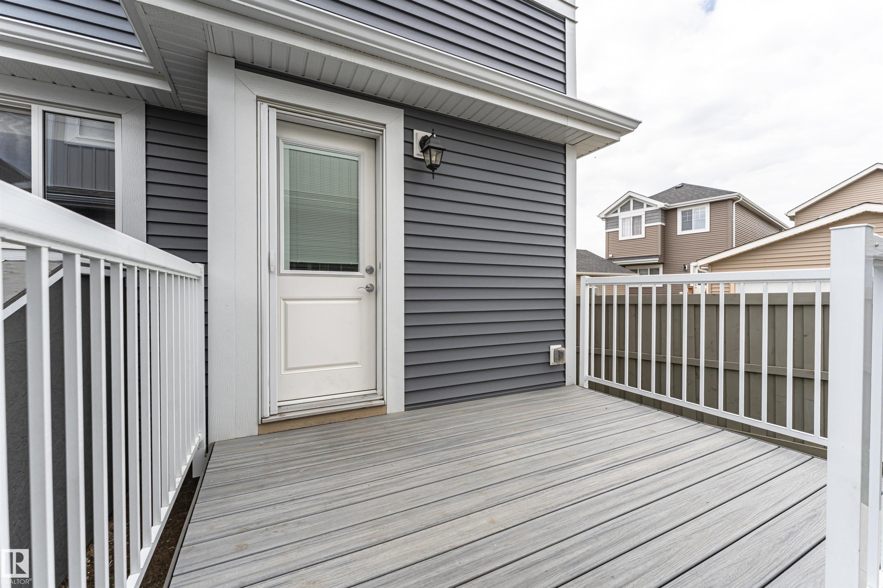 Exterior deck featuring composite decking and white railing - 22124 85 Avenue Nw, Edmonton, AB - Outdoor With Exterior