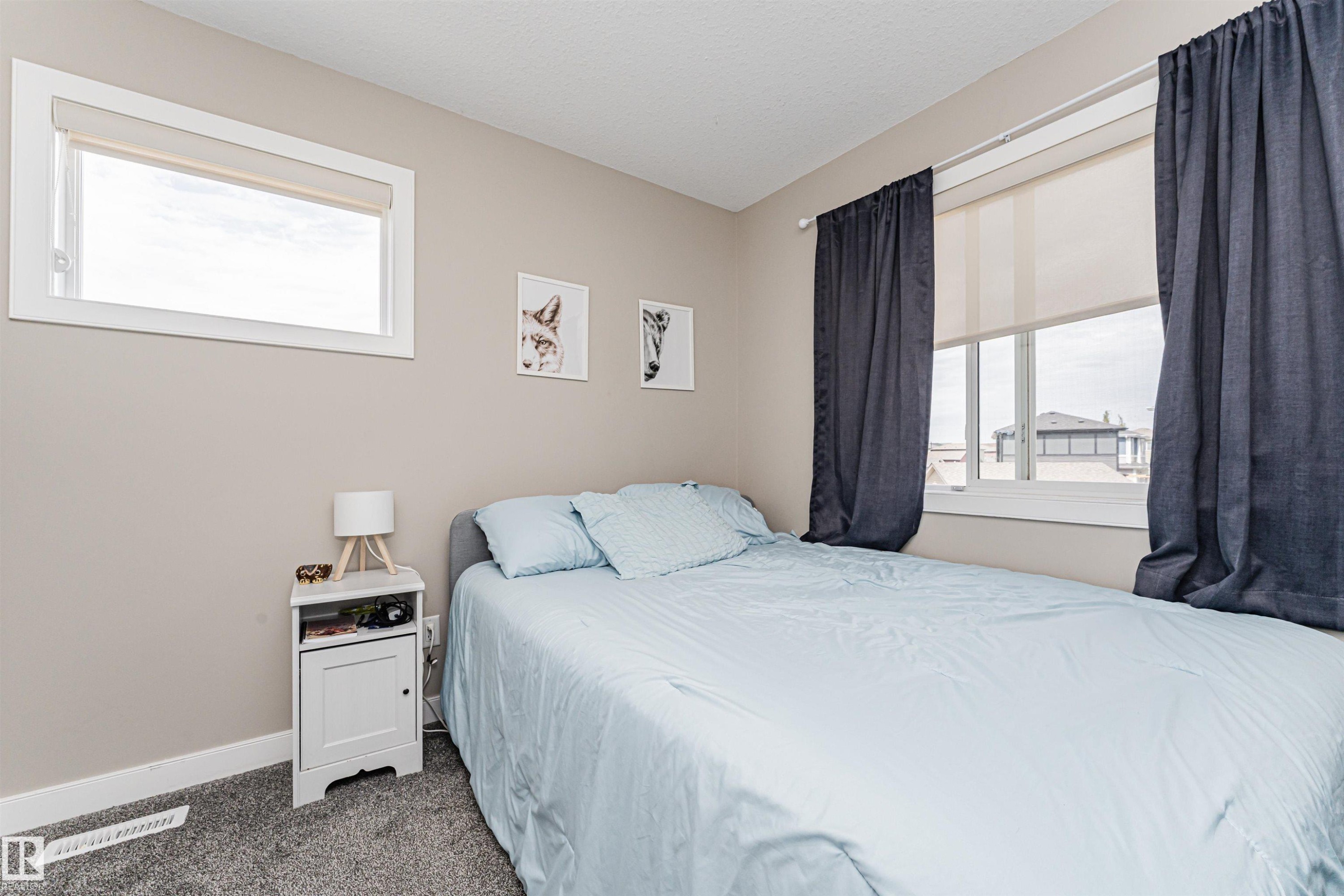 Bedroom featuring neutral wall paint, white trim, and gray carpet flooring - 22124 85 Avenue Nw, Edmonton, AB - Indoor Photo Showing Bedroom
