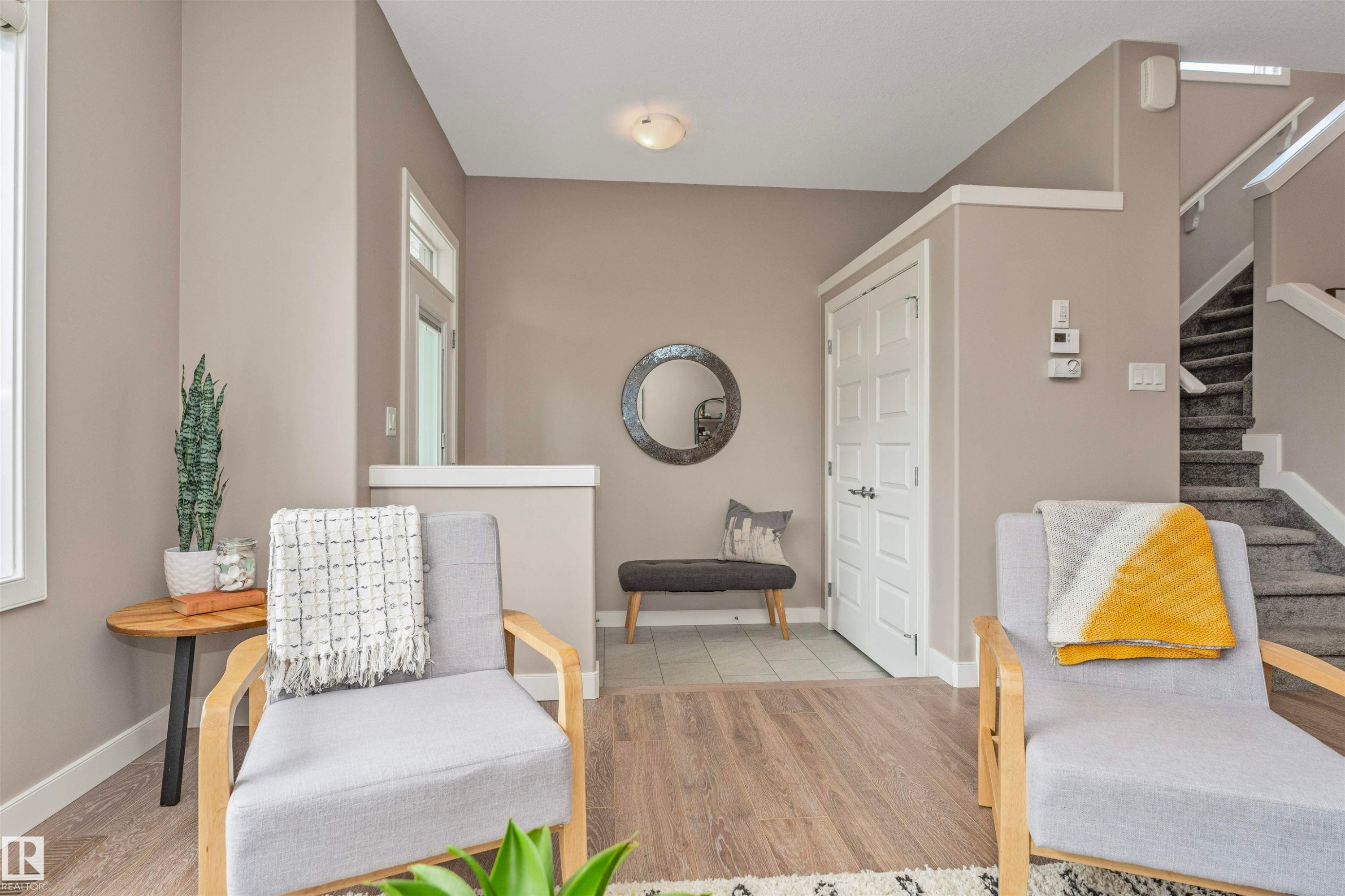 Entryway featuring wood-finish flooring, a paneled entry door, and a staircase with carpeted treads - 22124 85 Avenue Nw, Edmonton, AB - Indoor Photo Showing Other Room