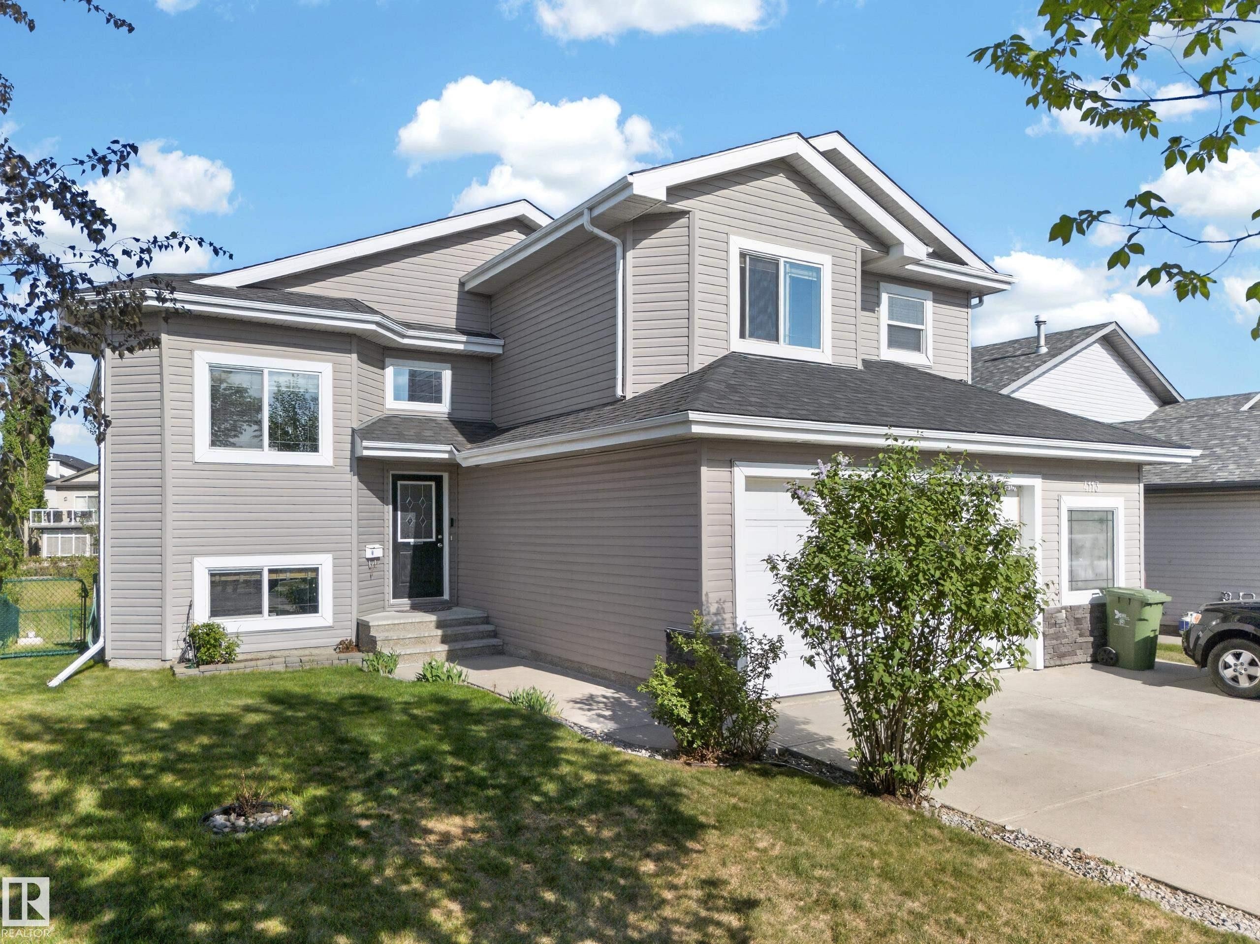 Modern two-story residence featuring light gray siding with white trim - 4113 59 Street, Beaumont, AB