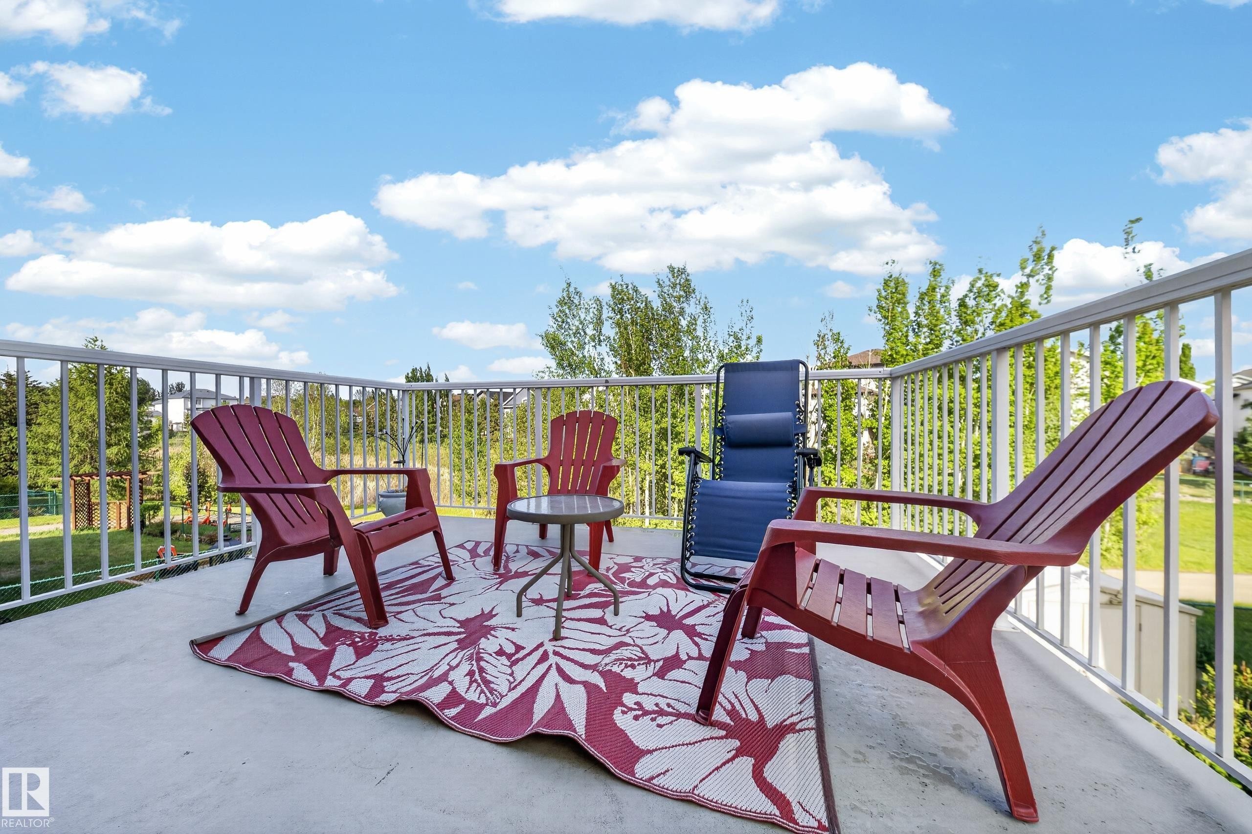 Concrete patio with white railing - 4113 59 Street, Beaumont, AB