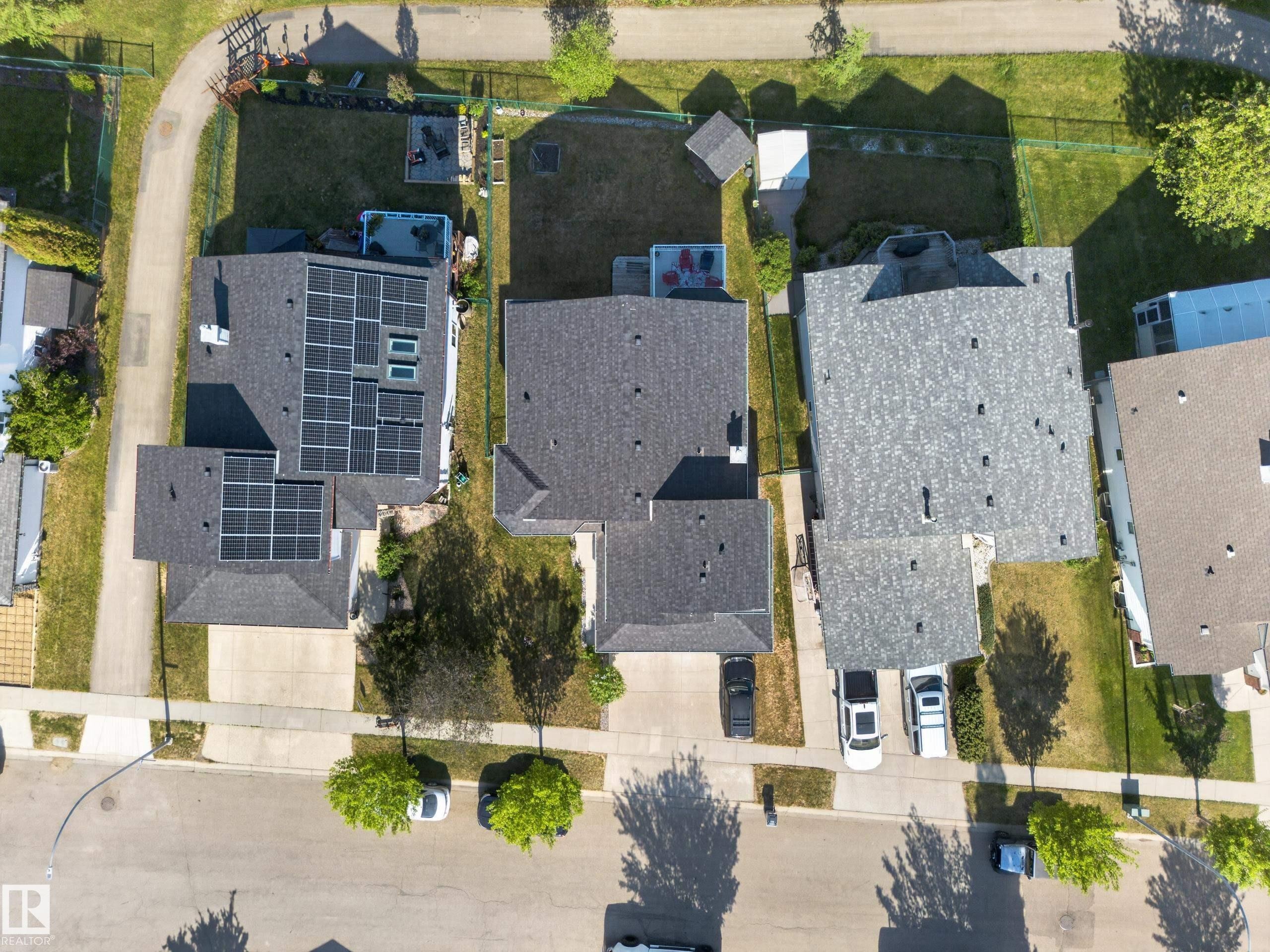Residential property with a dark shingle roof and extensive solar panel installation - 4113 59 Street, Beaumont, AB
