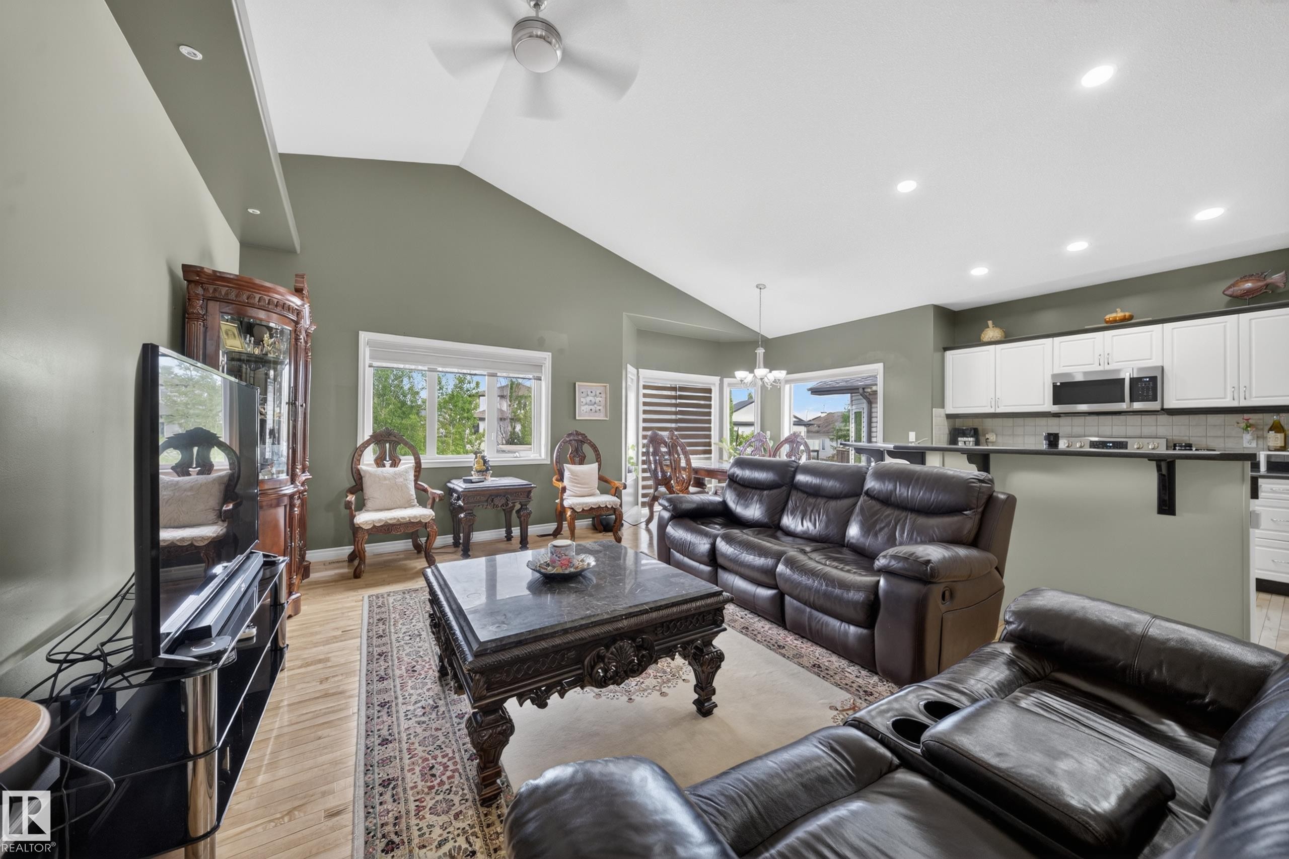 Spacious living area featuring vaulted ceilings, recessed lighting, and wood-finish flooring - 4113 59 Street, Beaumont, AB