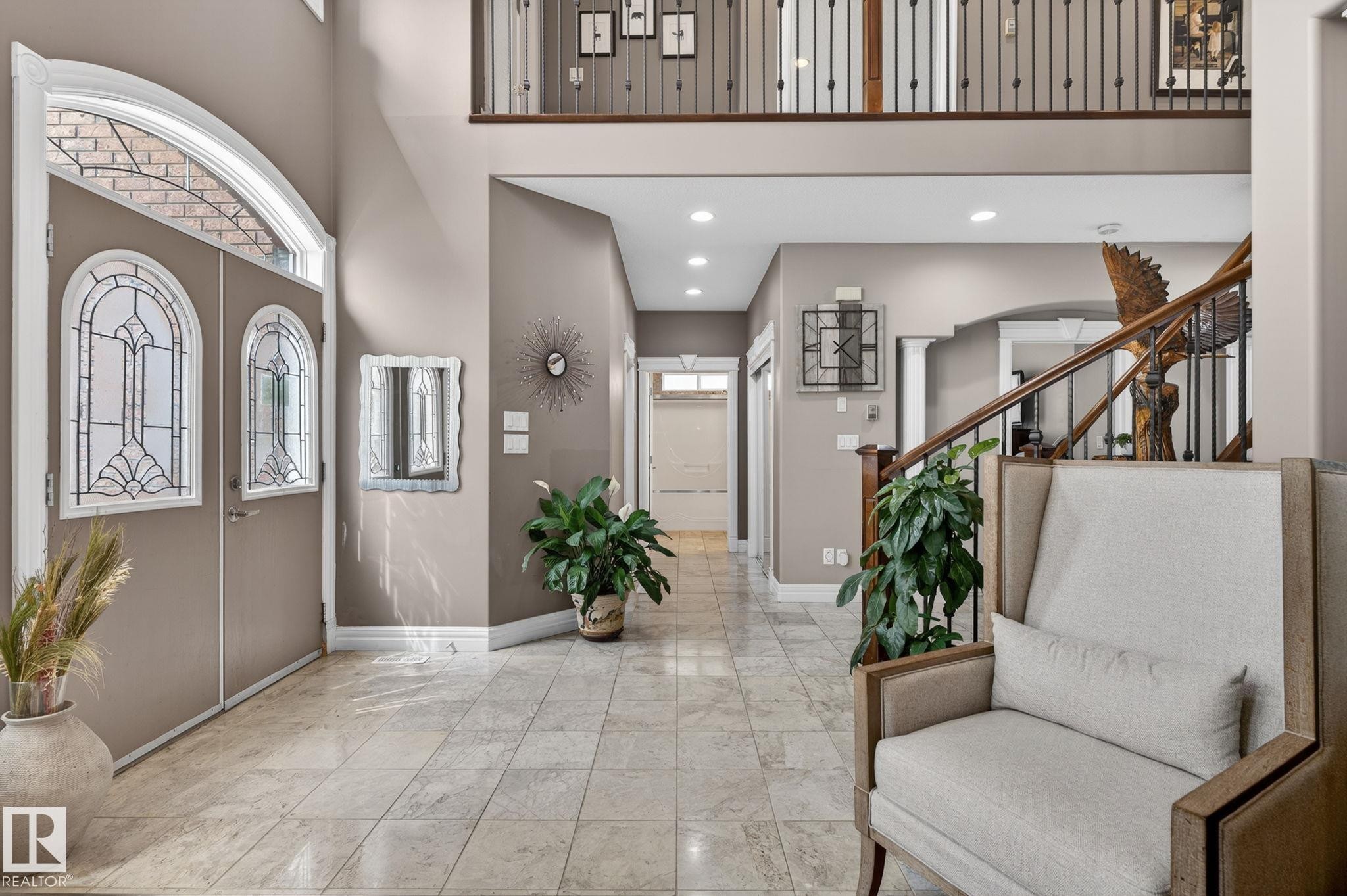 Brick exterior with stone accents and a prominent two-story window feature - 1508 Palmer Close, Edmonton, AB