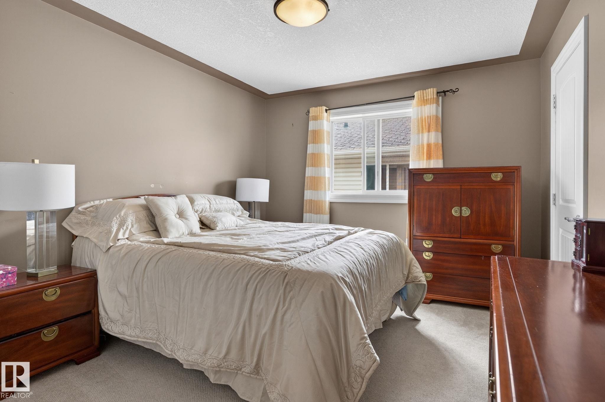 Kitchen featuring granite countertops, wood cabinetry, stainless steel appliances, and tile flooring - 1508 Palmer Close, Edmonton, AB