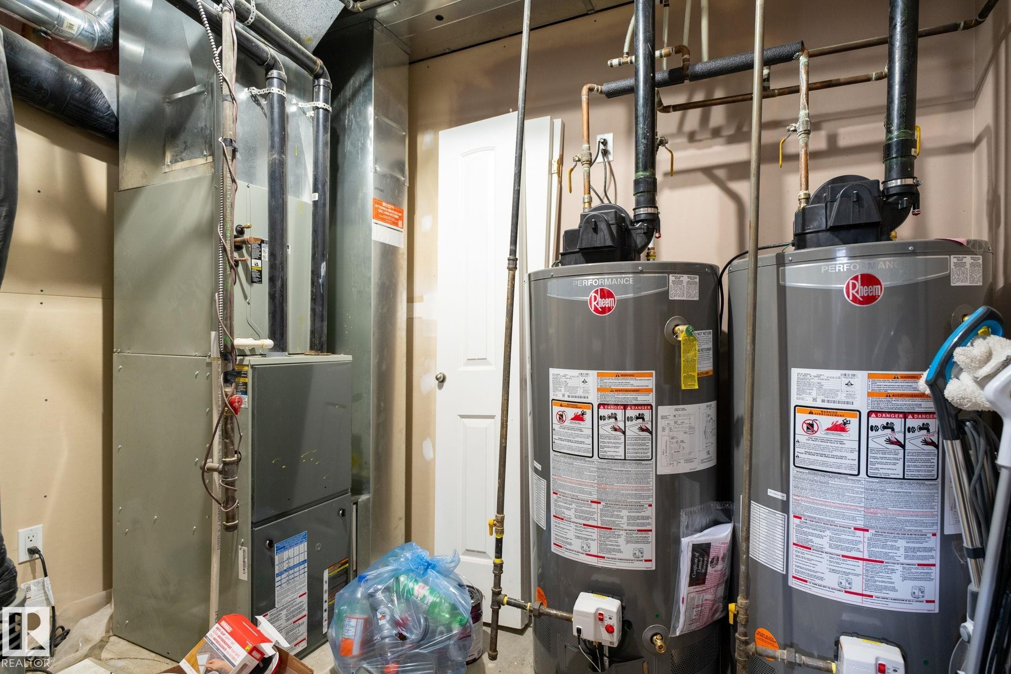Utility room featuring a forced-air furnace and two large capacity water heaters - 1508 Palmer Close, Edmonton, AB
