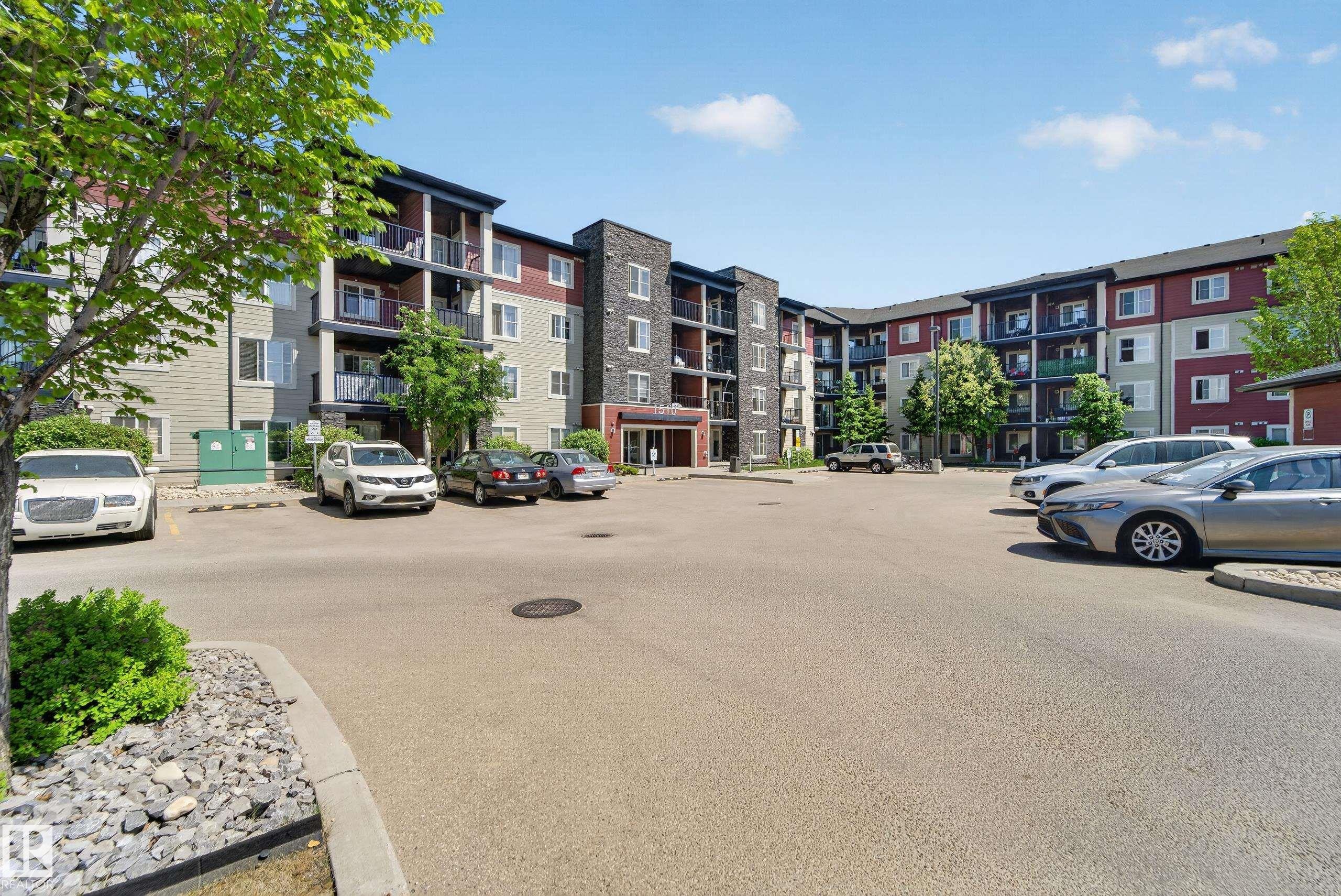Contemporary multi-story building featuring varied exterior finishes including stone accents, siding, and multiple private balconies - 225 1510 Watt Drive, Edmonton, AB - Outdoor With Facade
