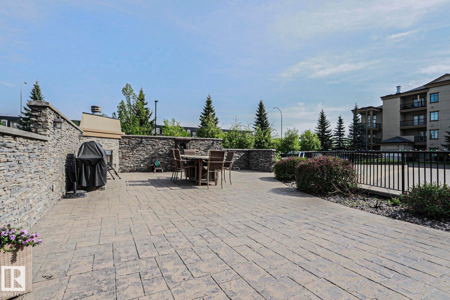 Expansive outdoor patio featuring stamped concrete flooring - 117 160 Magrath Road, Edmonton, AB - Outdoor