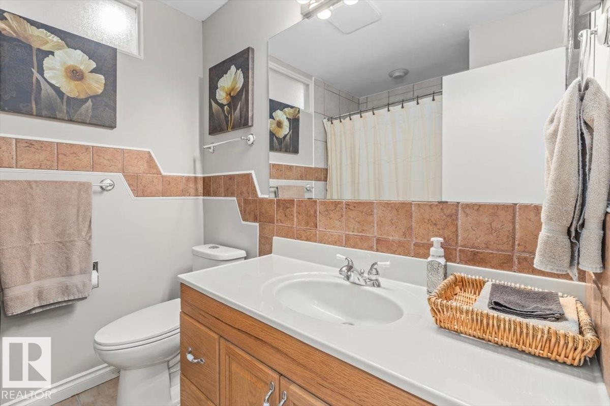 Upper floor Bathroom featuring a light wood-finish vanity with a white countertop and integrated sink - 6720 29 Avenue, Edmonton, AB