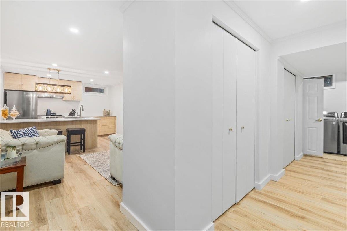 Light wood-finish flooring extending through the space - 6720 29 Avenue, Edmonton, AB