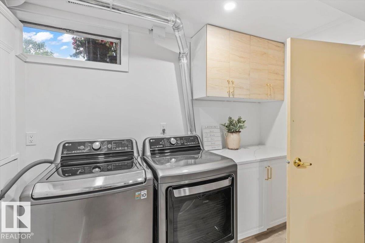 Dedicated laundry area featuring a built-in countertop, light wood-finish upper cabinetry, white lower cabinetry with gold-tone hardware, and a high window - 6720 29 Avenue, Edmonton, AB