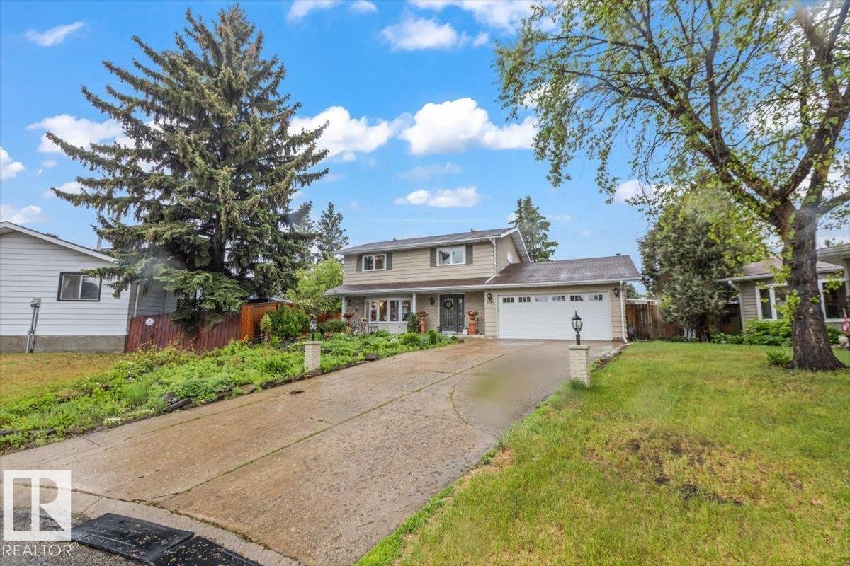 Two-story residence featuring light-colored siding and a white garage door - 6720 29 Avenue, Edmonton, AB