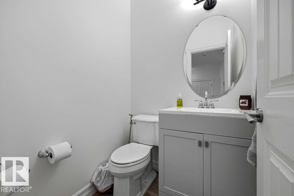 Powder room featuring a single vanity with a white countertop and base cabinetry - 13703 166 Avenue Nw, Edmonton, AB - Indoor Photo Showing Bathroom