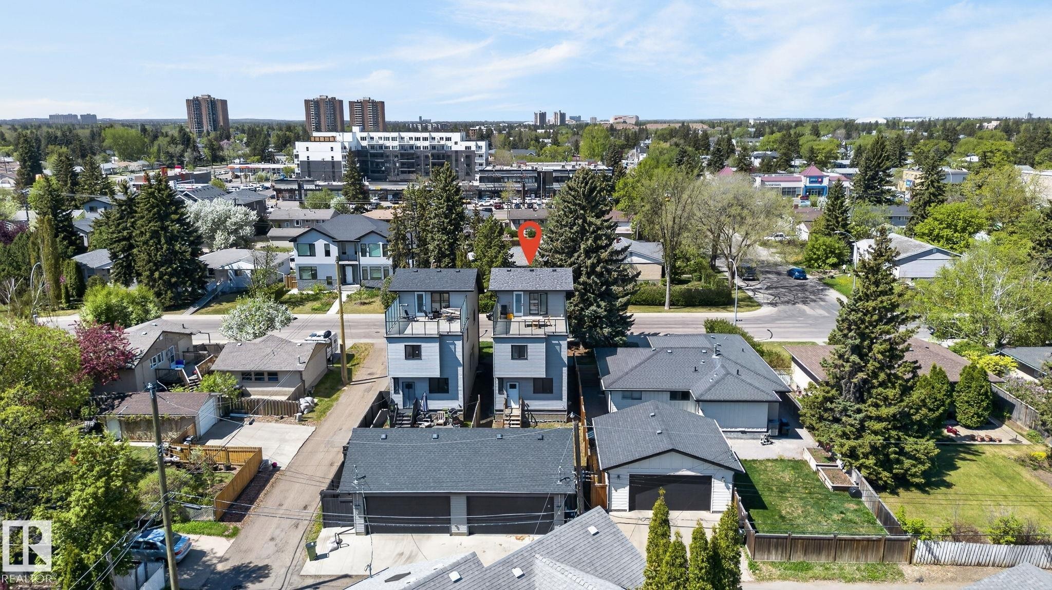 Contemporary residential building featuring light blue siding and dark gray trim - 8809 148 Street, Edmonton, AB - Outdoor With View