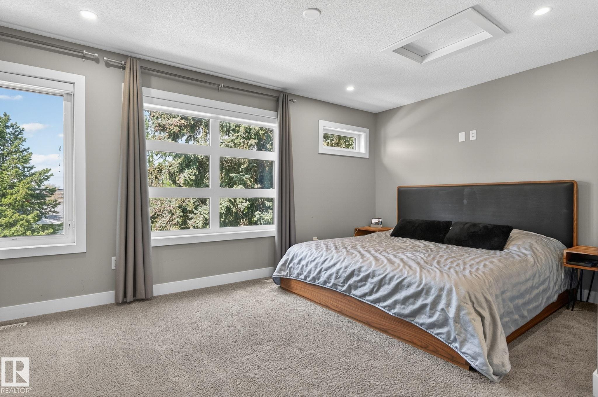 Carpeted room featuring multiple windows with trim, recessed lighting, and a ceiling light panel - 8809 148 Street, Edmonton, AB - Indoor Photo Showing Bedroom