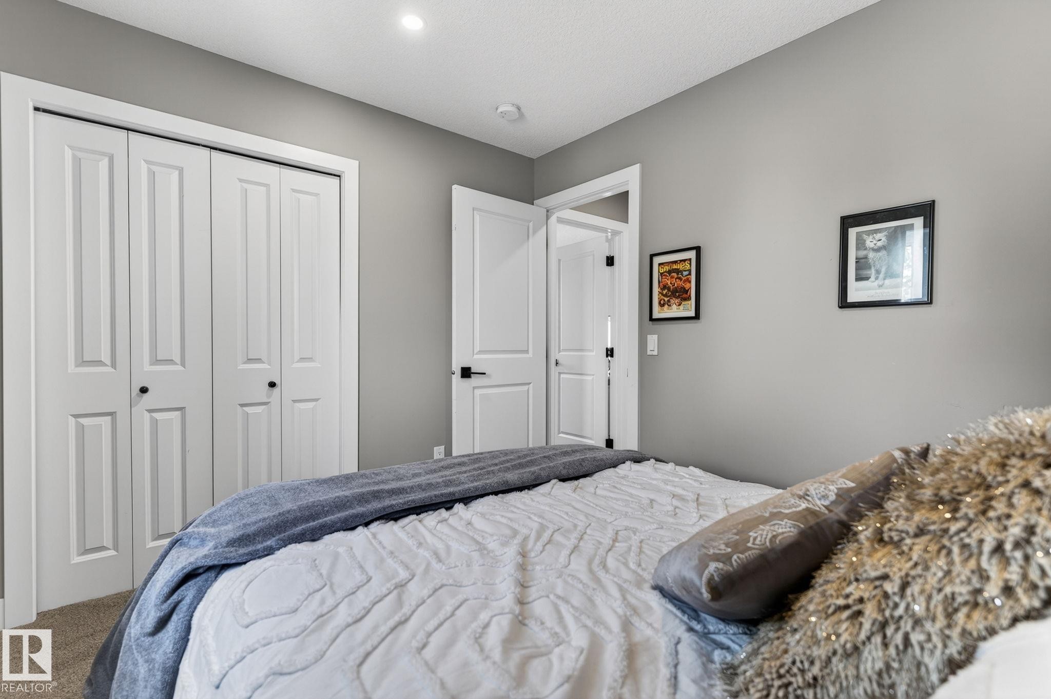 Neutral gray wall paint complementing white trim and interior doors - 8809 148 Street, Edmonton, AB - Indoor Photo Showing Bedroom