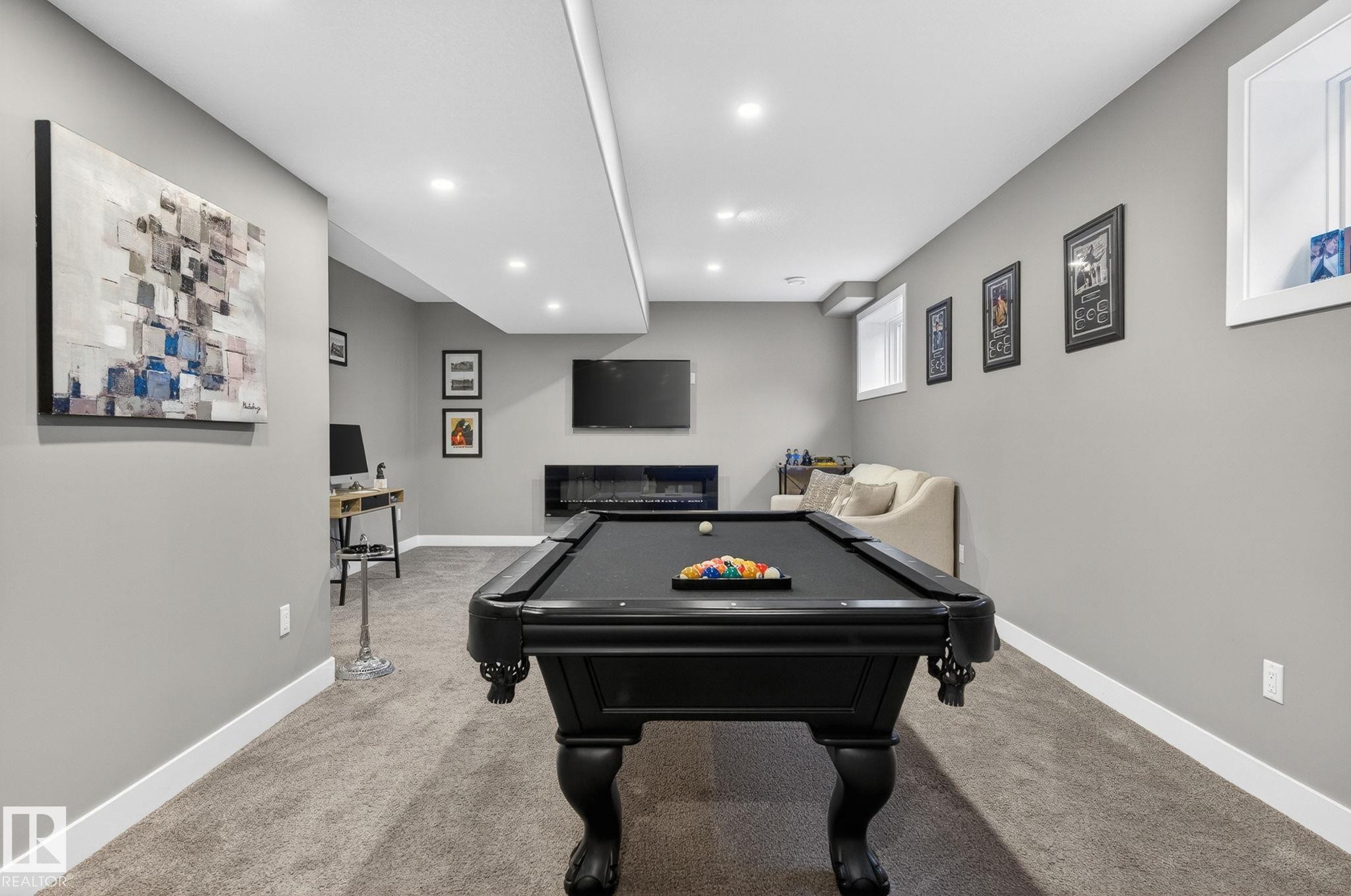 Recreation room featuring a pool table, wall-mounted television, built-in linear fireplace, recessed lighting, and light gray walls with white baseboards - 8809 148 Street, Edmonton, AB - Indoor Photo Showing Other Room