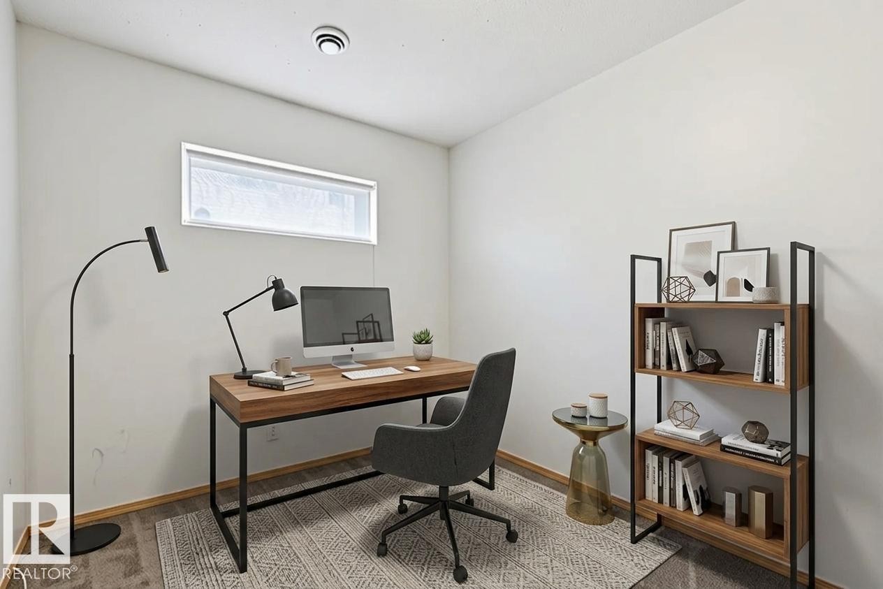 Versatile room featuring a horizontal window, recessed ceiling light, and wood-finish flooring - 1 225 Blackburn Drive E, Edmonton, AB