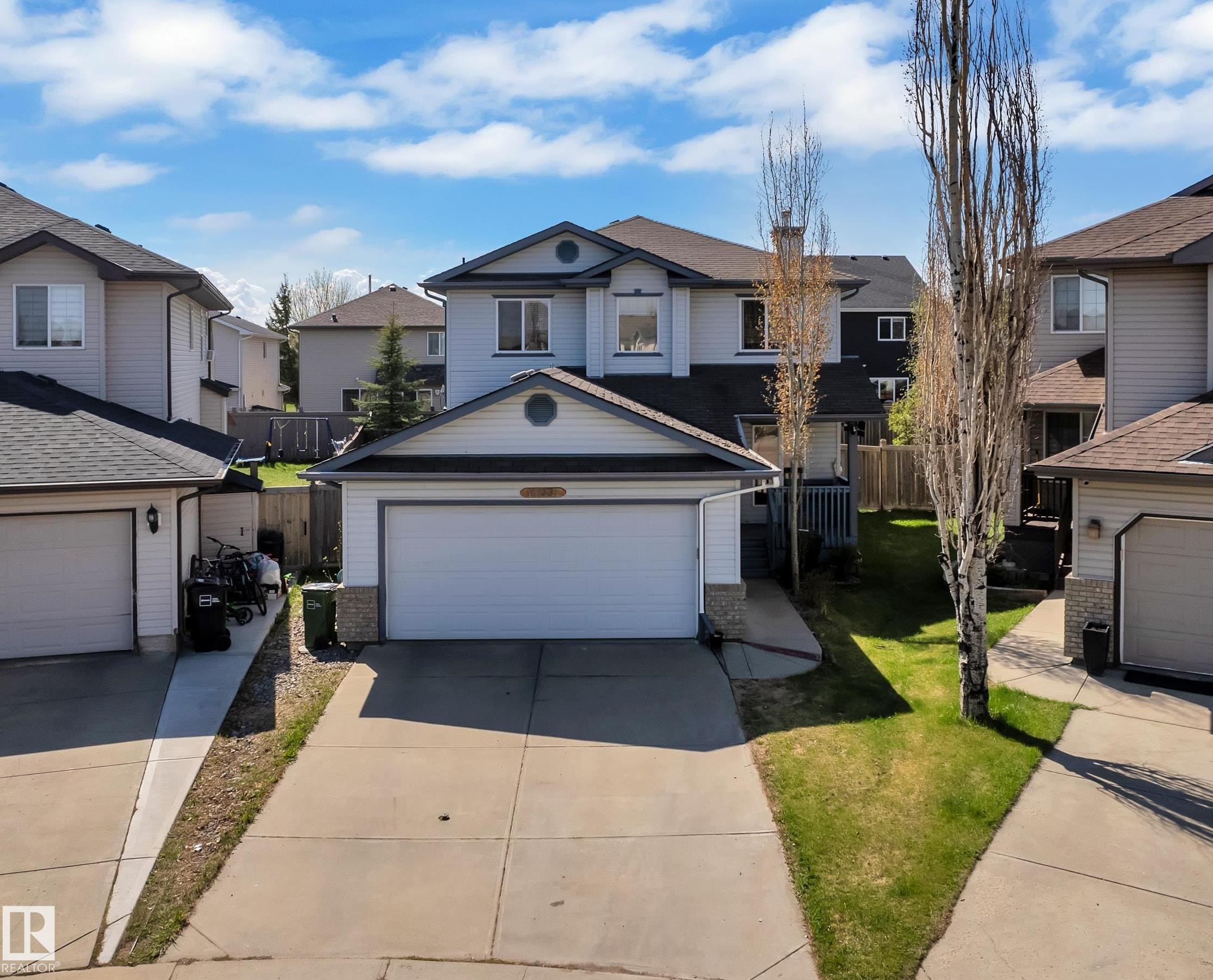 Two-story residence featuring a front-facing attached garage and a concrete driveway - 14031 136 Street, Edmonton, AB
