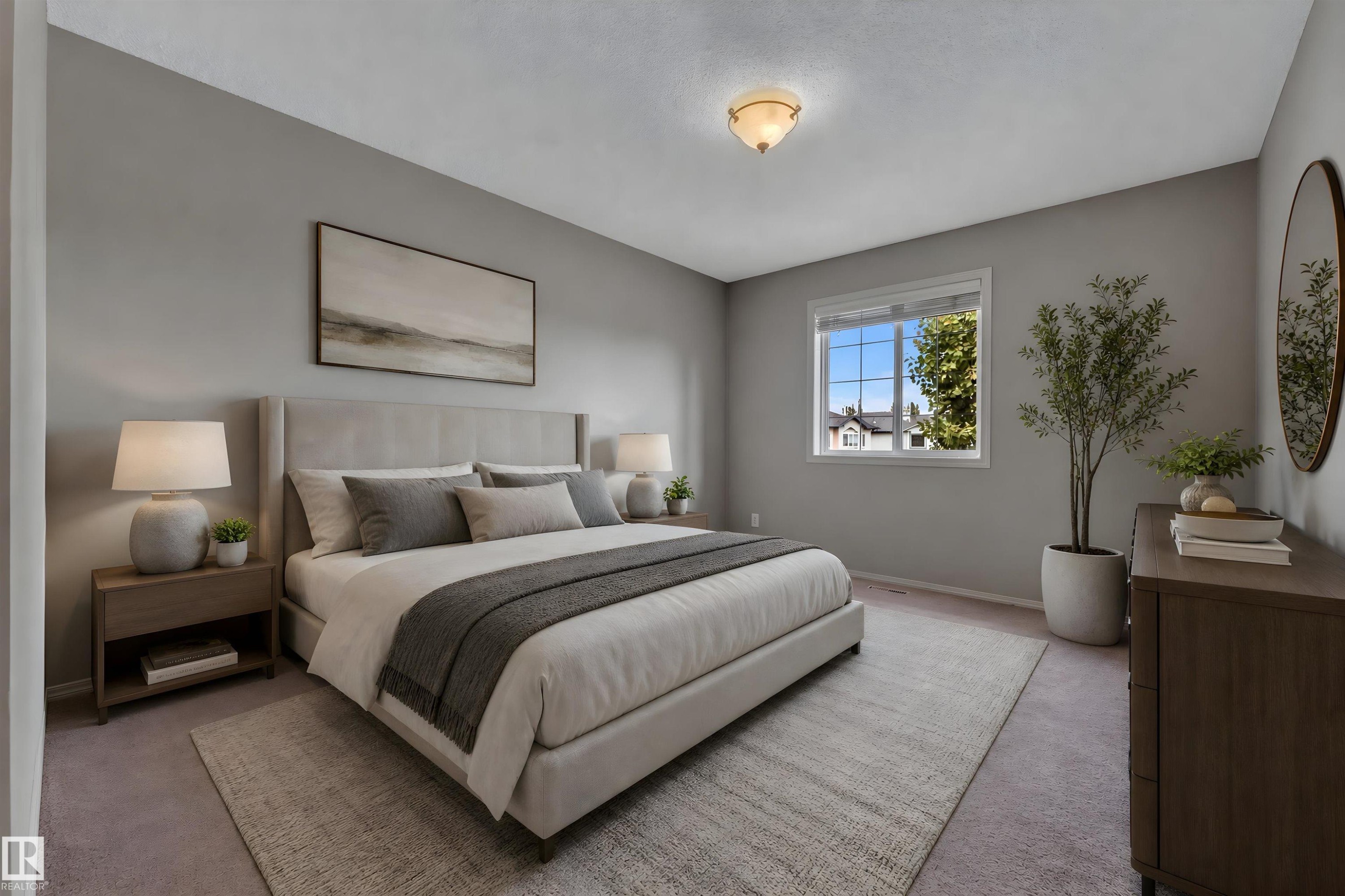 Spacious bedroom featuring light gray wall paint, a window with white trim, and a semi-flush ceiling light fixture - 14031 136 Street, Edmonton, AB