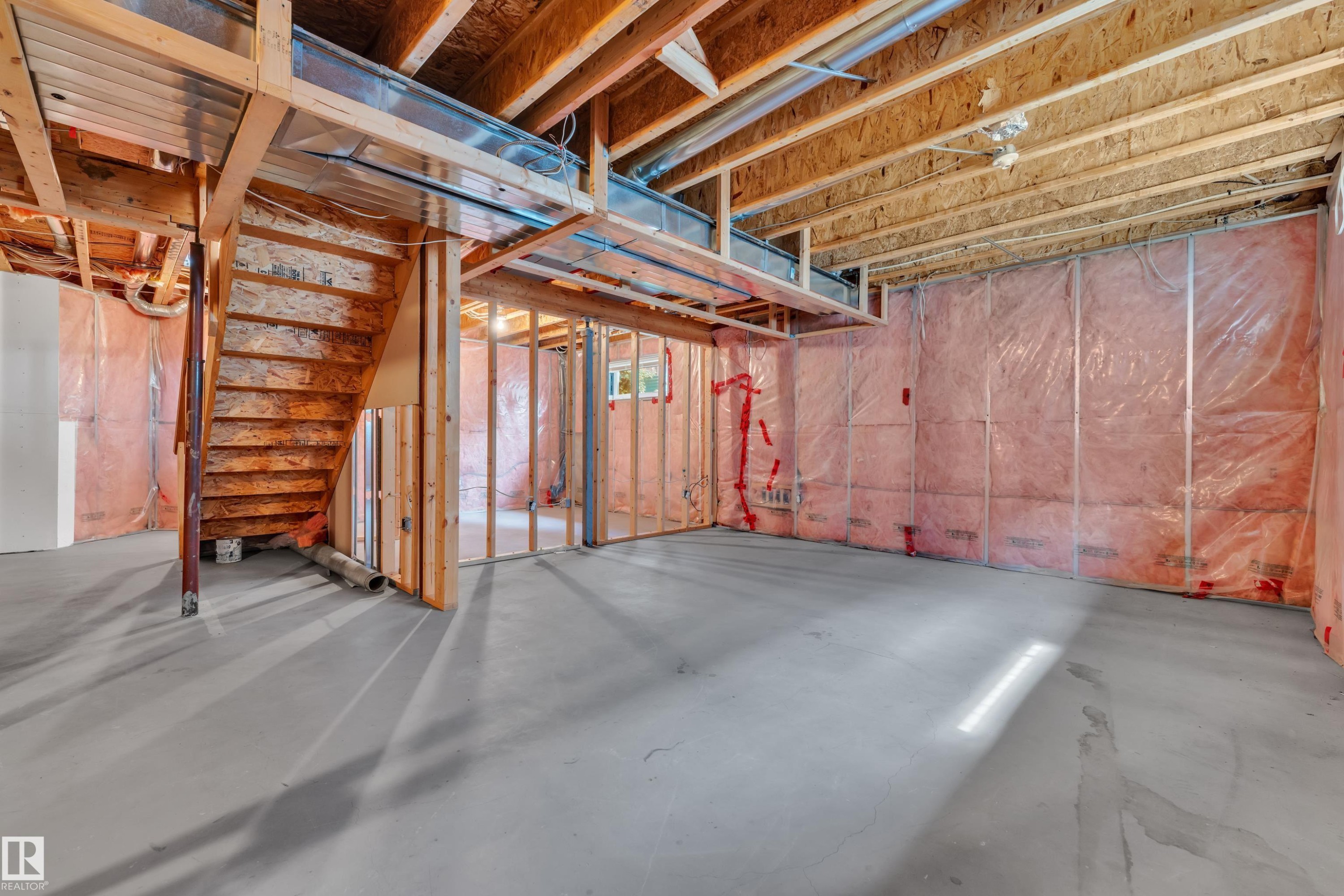 Unfinished basement space with exposed wood framing, concrete flooring, and insulated walls - 14031 136 Street, Edmonton, AB
