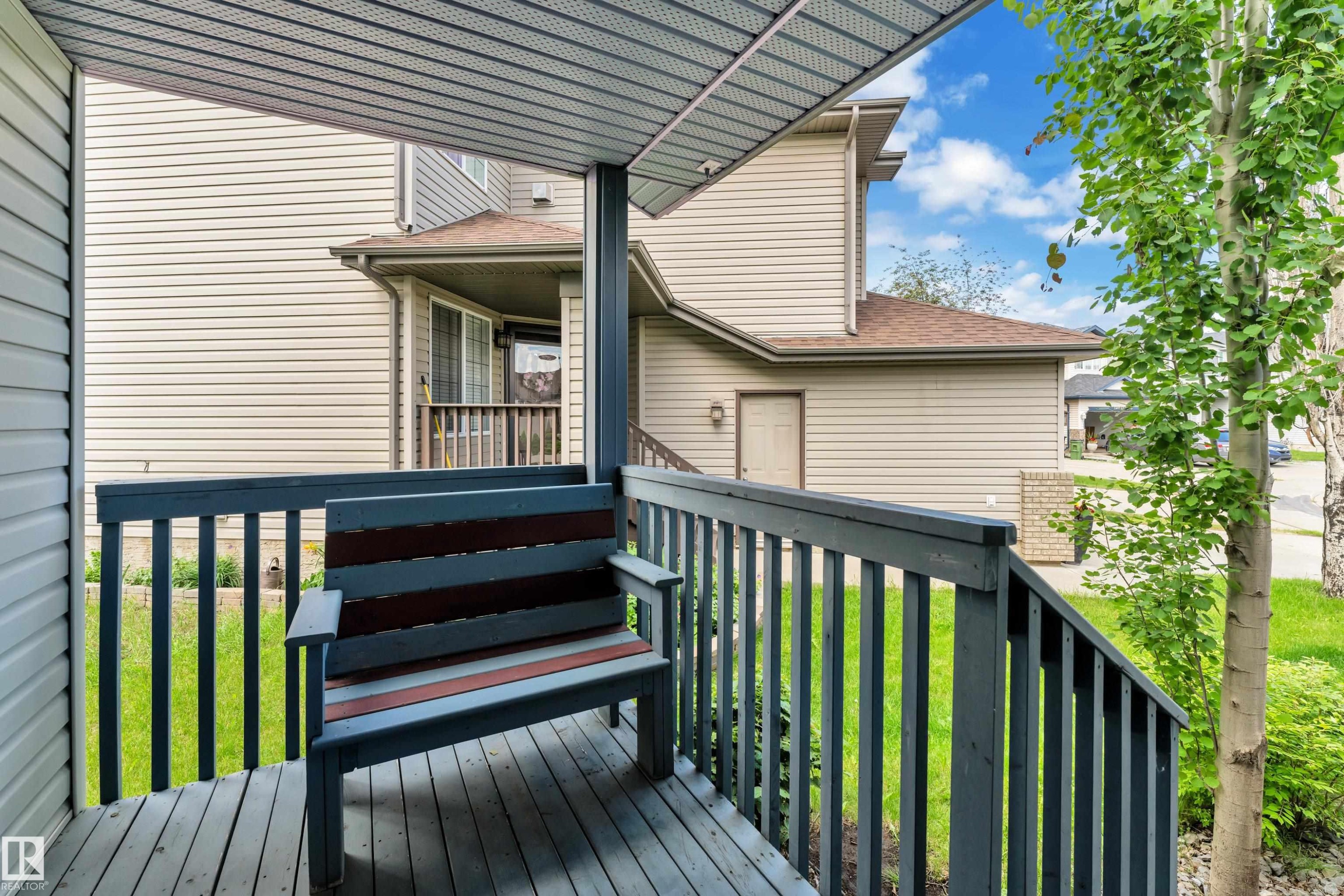 Covered deck featuring wood-finish decking and railings - 14031 136 Street, Edmonton, AB