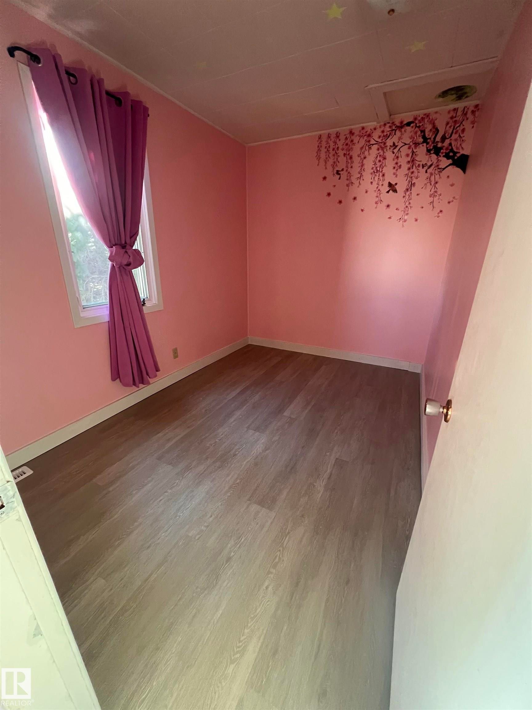 Room featuring light wood-finish flooring, a single window, and light-colored walls - 69 Railway Avenue, Star, AB