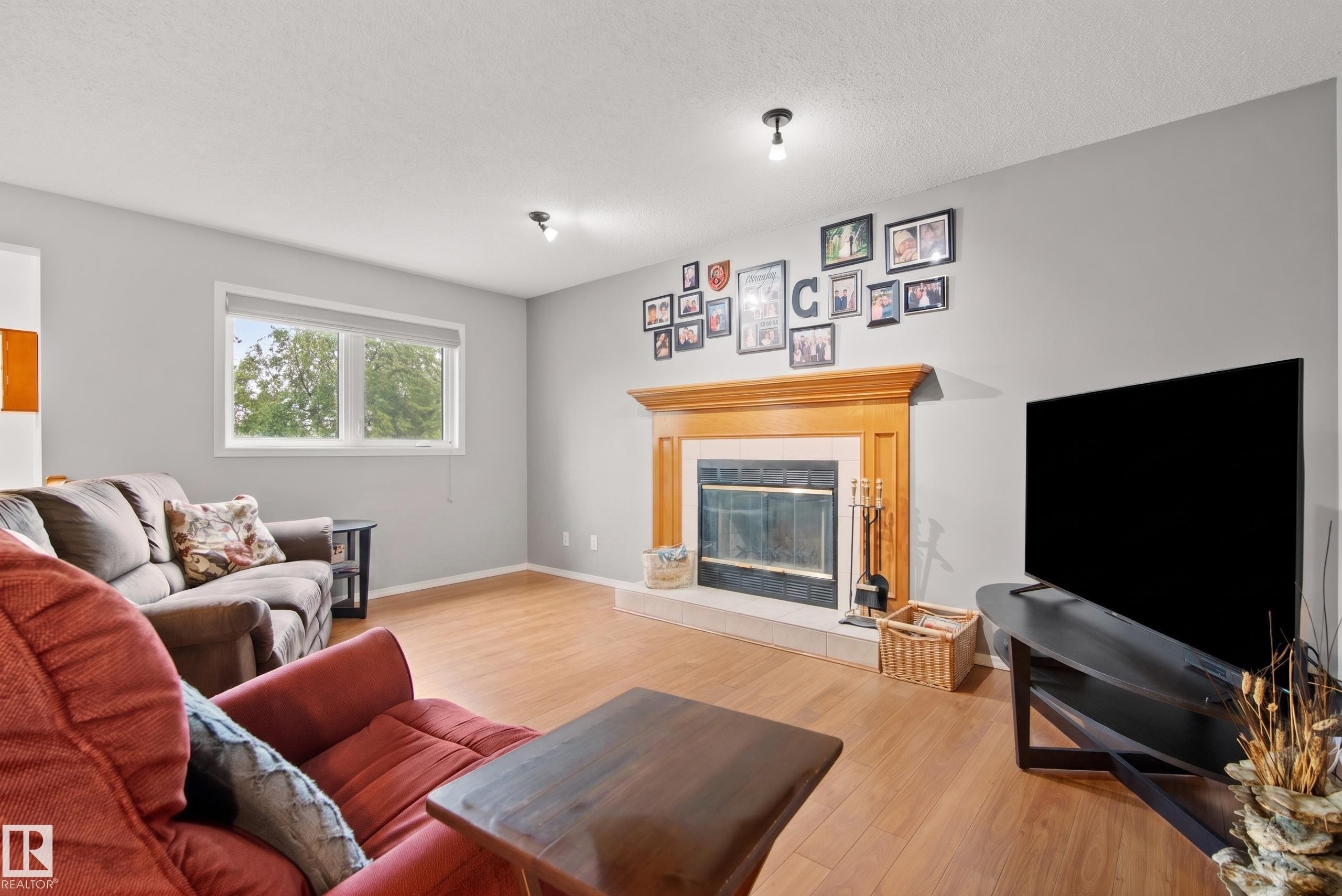 Living area featuring light wood-finish flooring and neutral wall tones - 15503 62 Street, Edmonton, AB