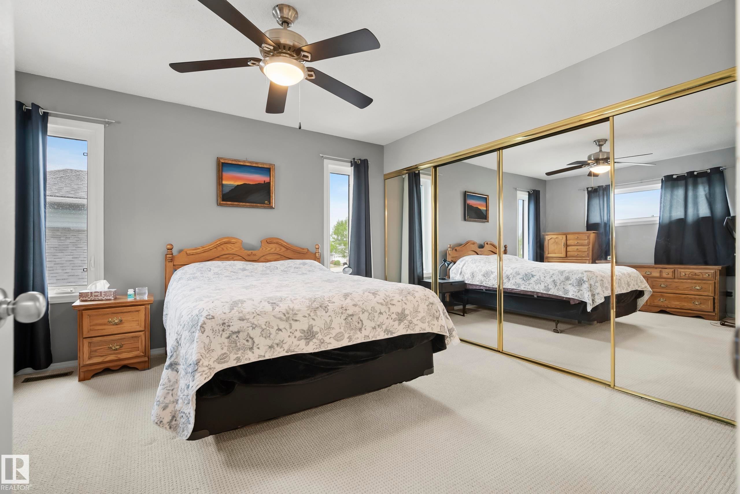 Expansive mirrored closet doors with gold-tone framing - 15503 62 Street, Edmonton, AB