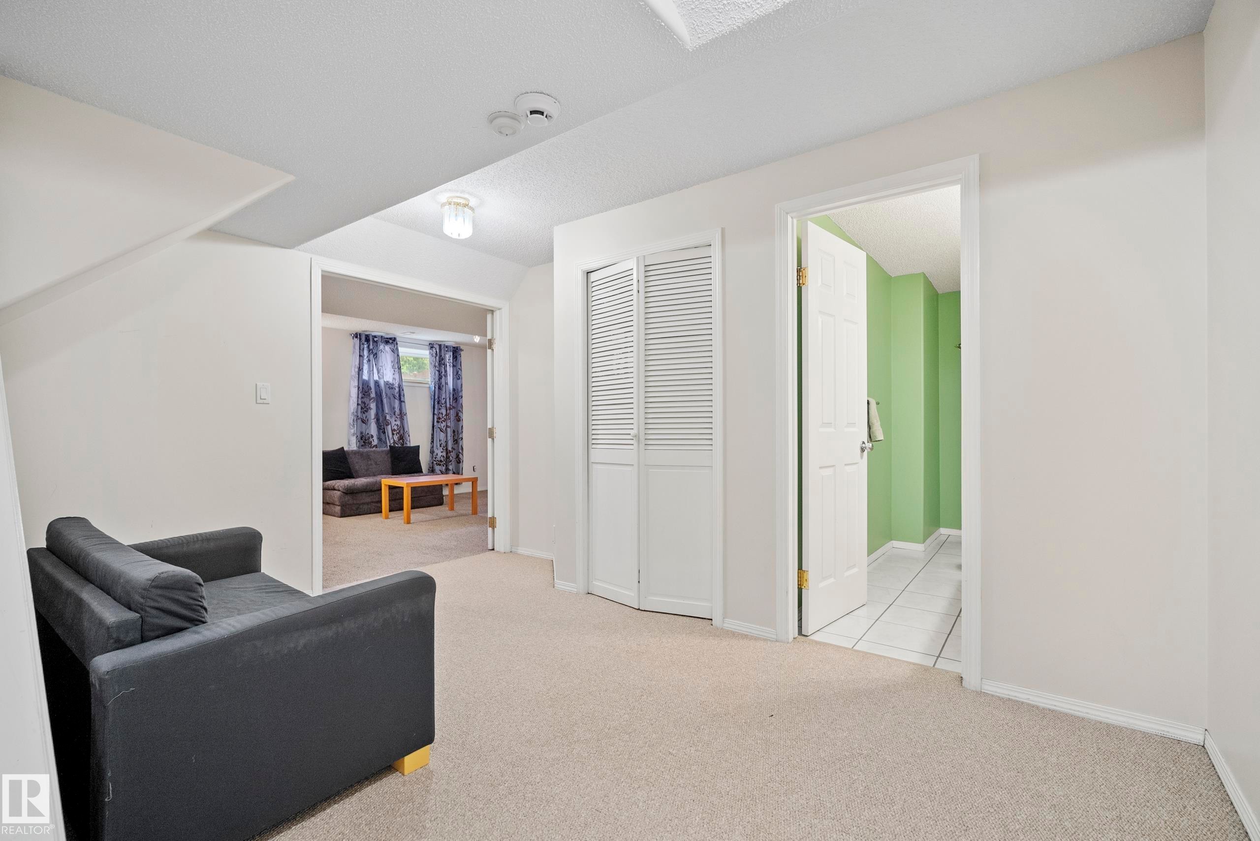 Carpeted interior area with white walls and ceiling - 15503 62 Street, Edmonton, AB