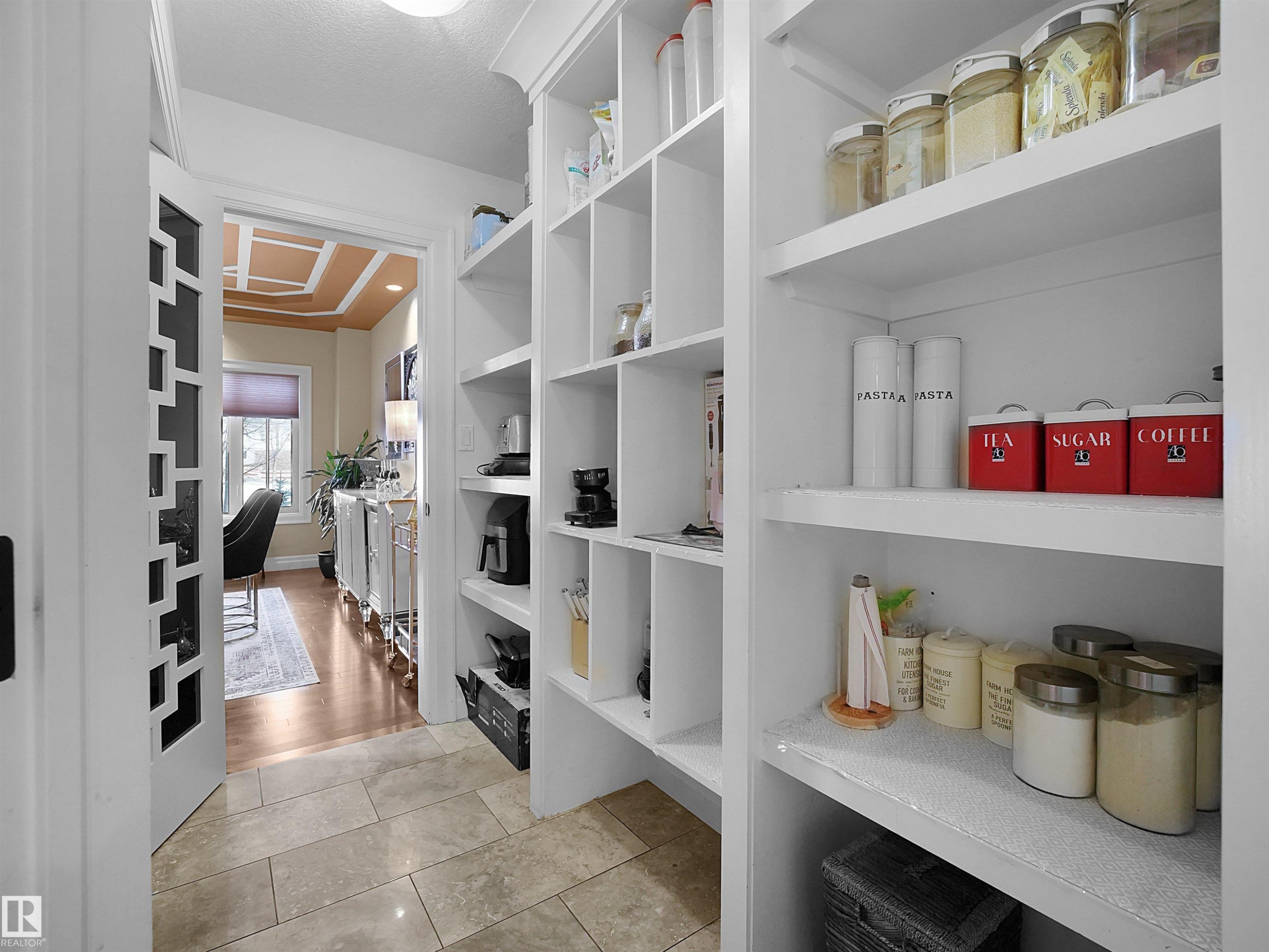 Built-in white shelving with varied compartment sizes, recessed lighting, and rectangular tile flooring - 2019 Cameron Ravine Way Nw, Edmonton, AB