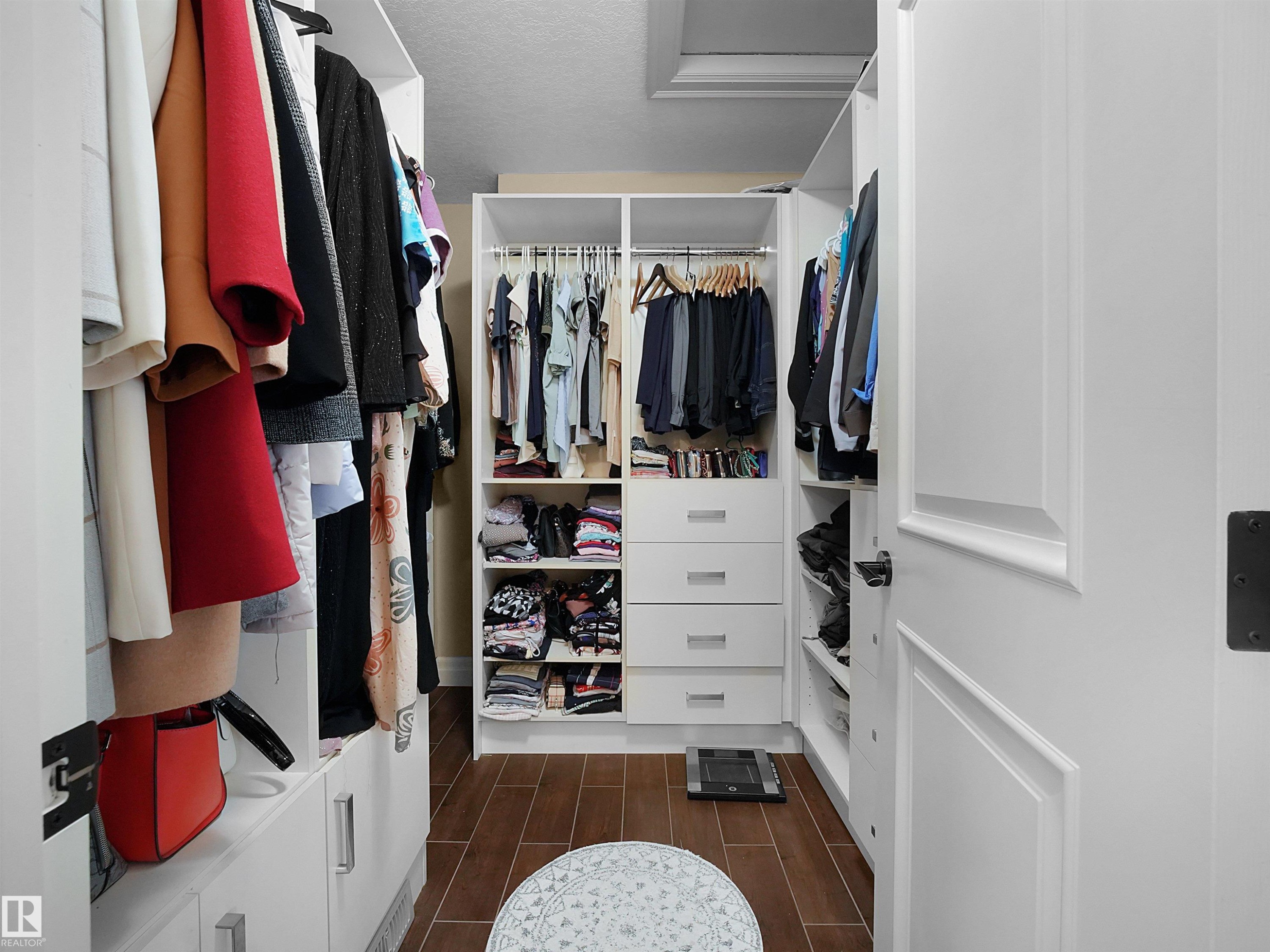 Custom white built-in closet system with multiple hanging rods and shelving - 2019 Cameron Ravine Way Nw, Edmonton, AB