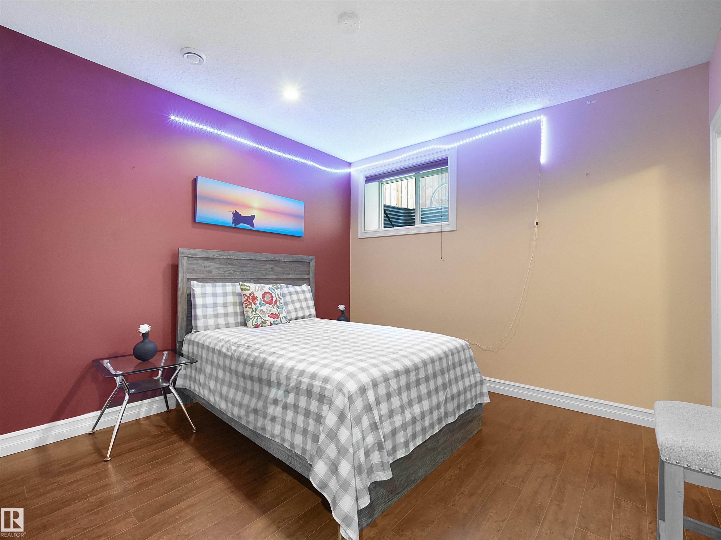 Bedroom featuring wood-finish flooring, two-tone wall paint, recessed ceiling lighting, and a window with blinds - 2019 Cameron Ravine Way Nw, Edmonton, AB