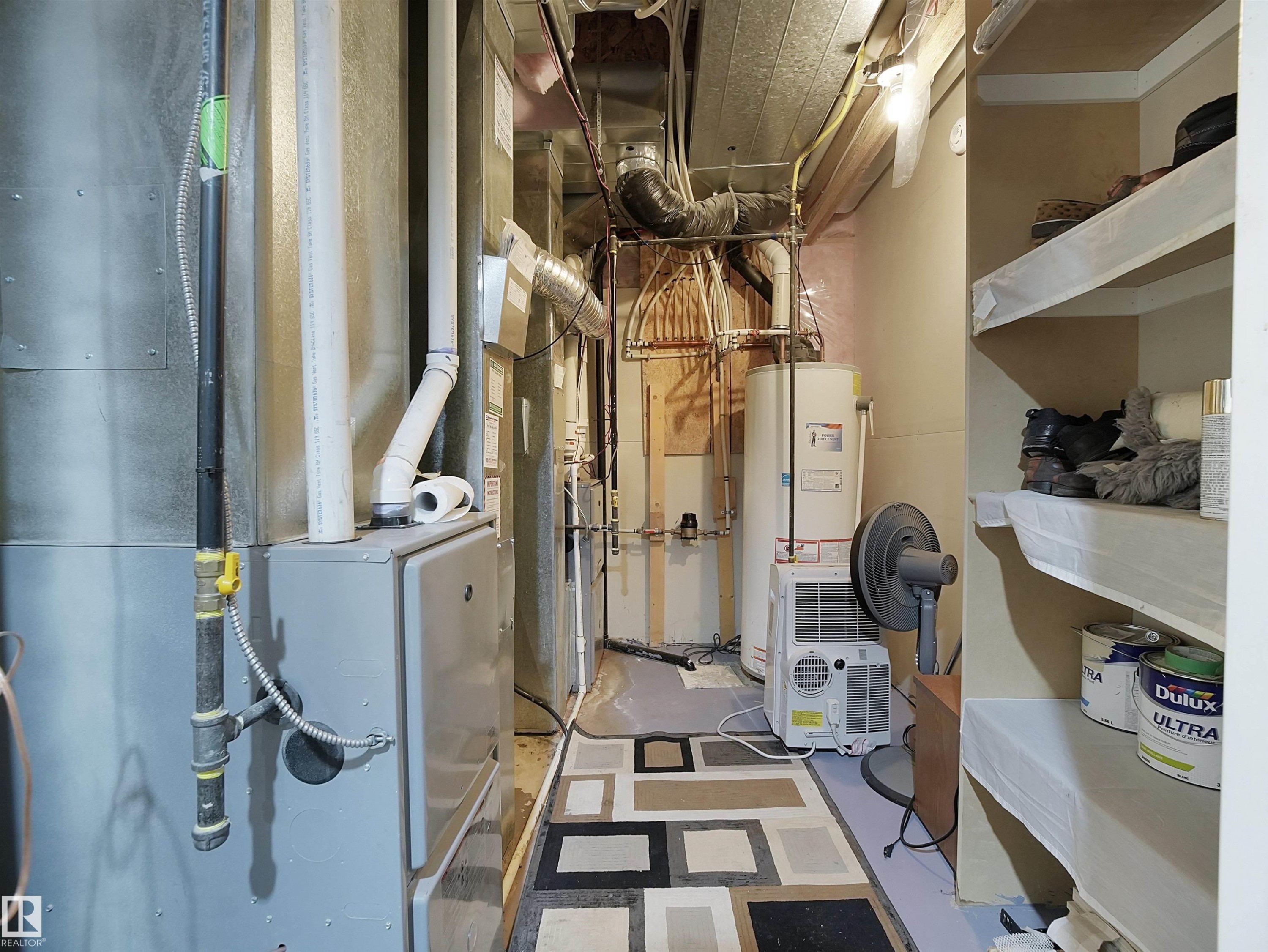 Utility area featuring a water heater, furnace, and exposed overhead ductwork - 2019 Cameron Ravine Way Nw, Edmonton, AB