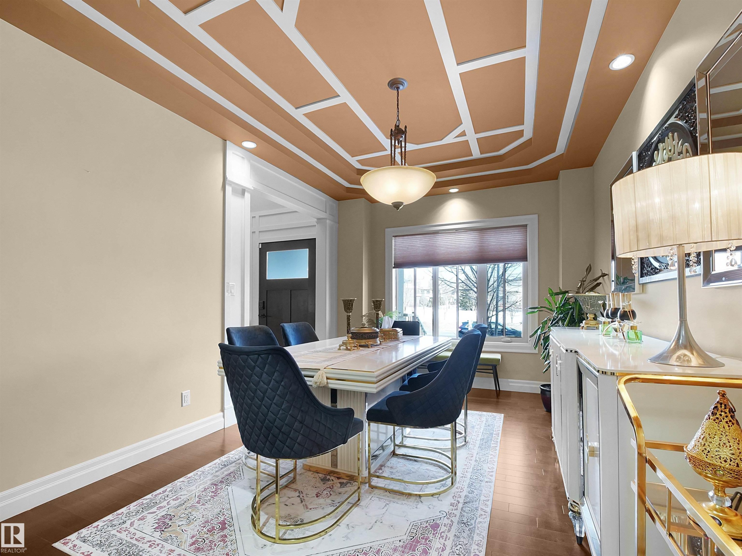Dining area featuring wood-finish flooring, a coffered ceiling with recessed lighting, and a chandelier - 2019 Cameron Ravine Way Nw, Edmonton, AB