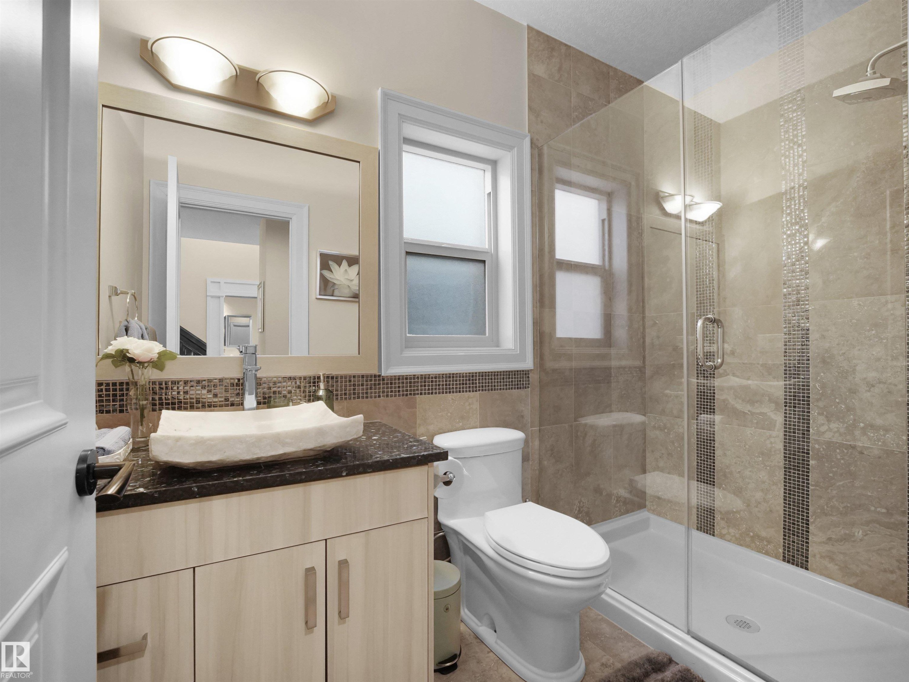 Contemporary bathroom featuring a light wood vanity with a dark countertop and vessel sink - 2019 Cameron Ravine Way Nw, Edmonton, AB