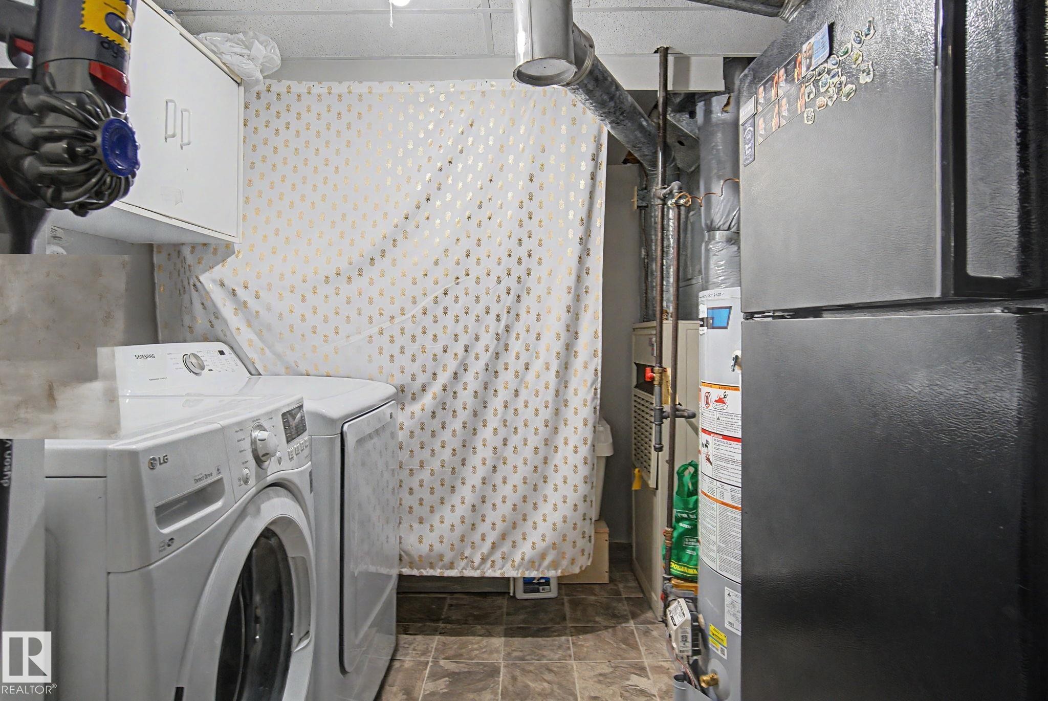 Dedicated utility space featuring durable tile flooring - 242 Northmount Drive, Wetaskiwin, AB
