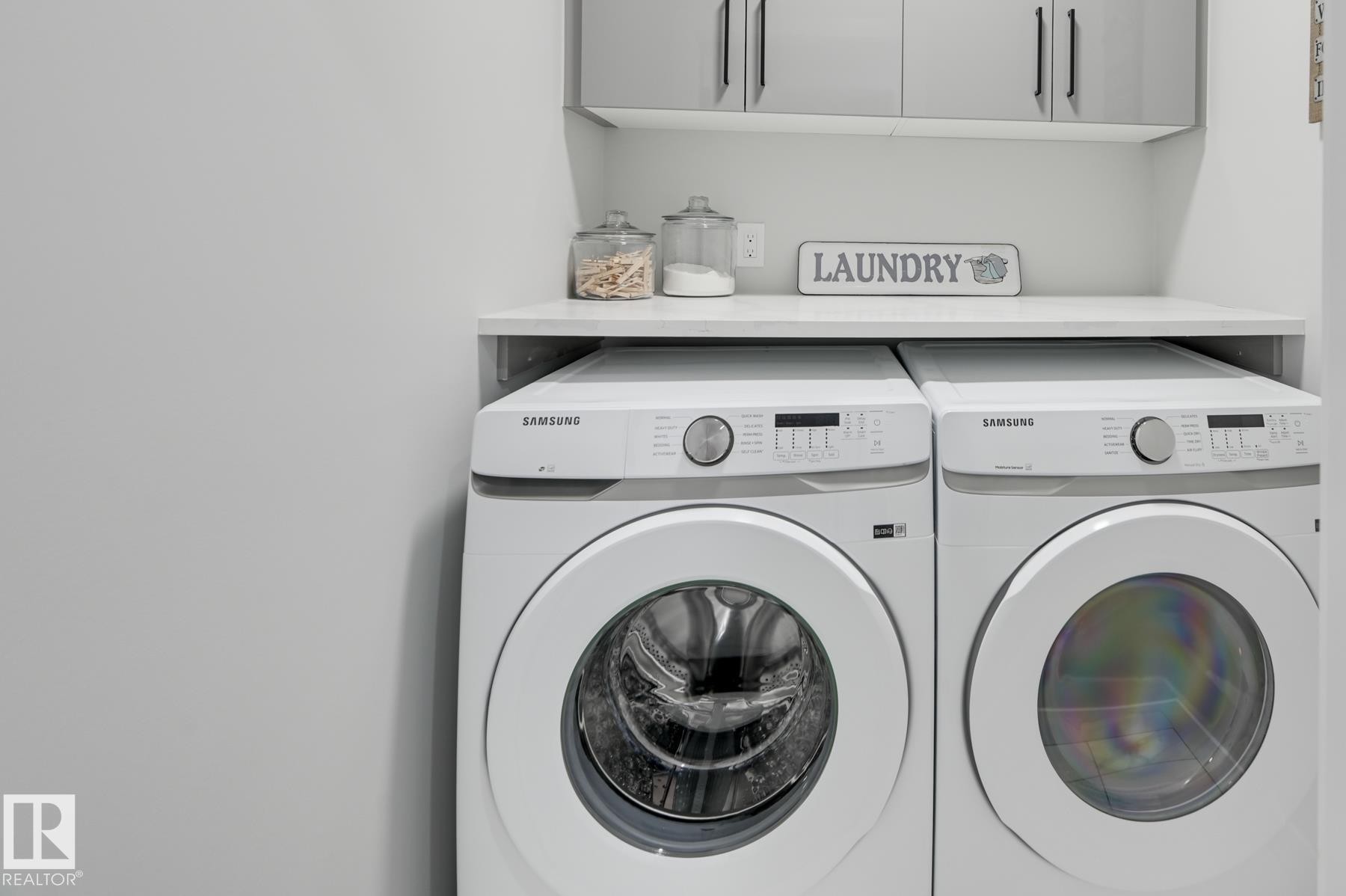 Dedicated laundry area featuring a white countertop with integrated shelving - 54 Chartres Close, St. Albert, AB - Indoor Photo Showing Laundry Room