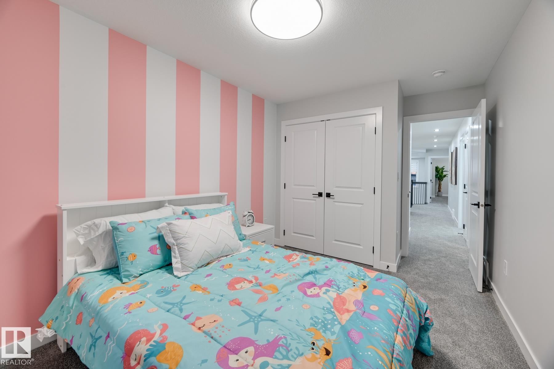 Bedroom featuring a prominent striped accent wall in white and pink tones - 54 Chartres Close, St. Albert, AB - Indoor Photo Showing Bedroom