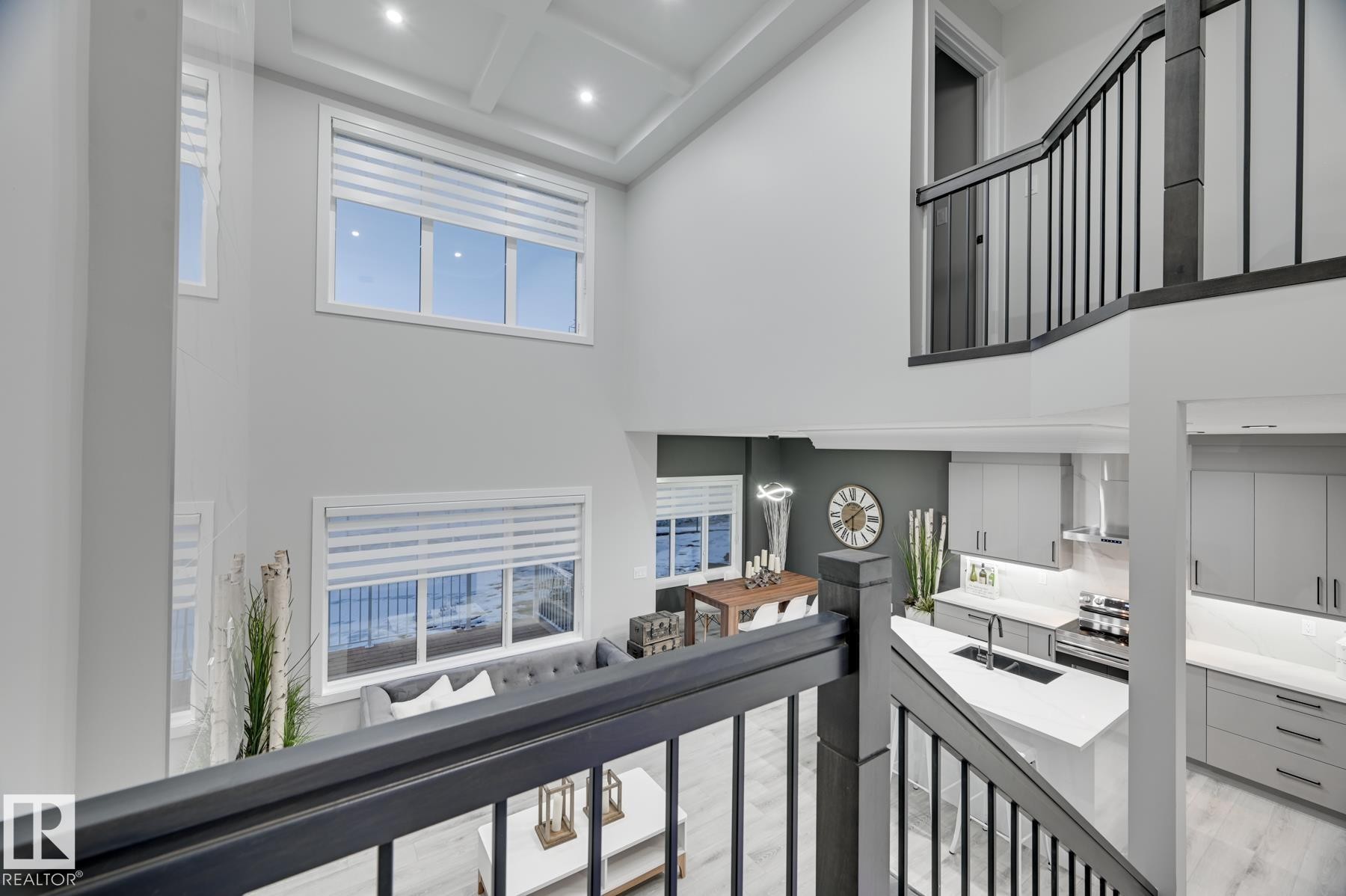 Two-story living area featuring a coffered ceiling, recessed lighting, and multiple large windows with blinds - 54 Chartres Close, St. Albert, AB - Indoor Photo Showing Other Room