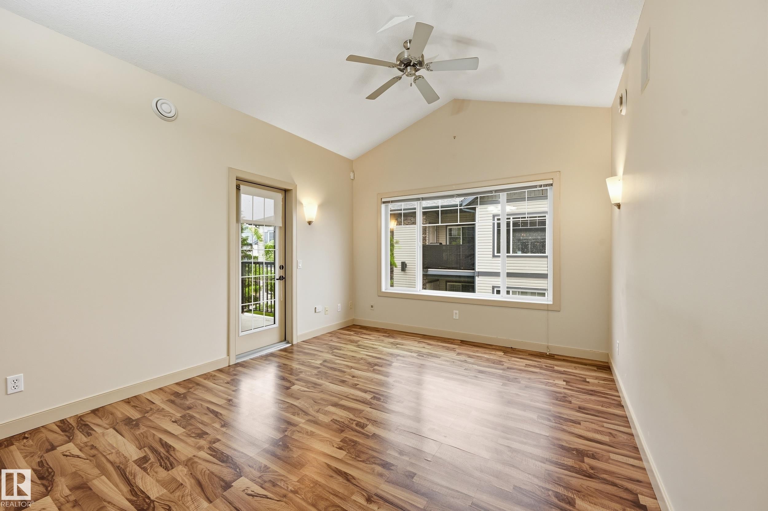 Room featuring wood-finish flooring, a vaulted ceiling, and a ceiling fan - 50 2565 Hanna Crescent, Edmonton, AB
