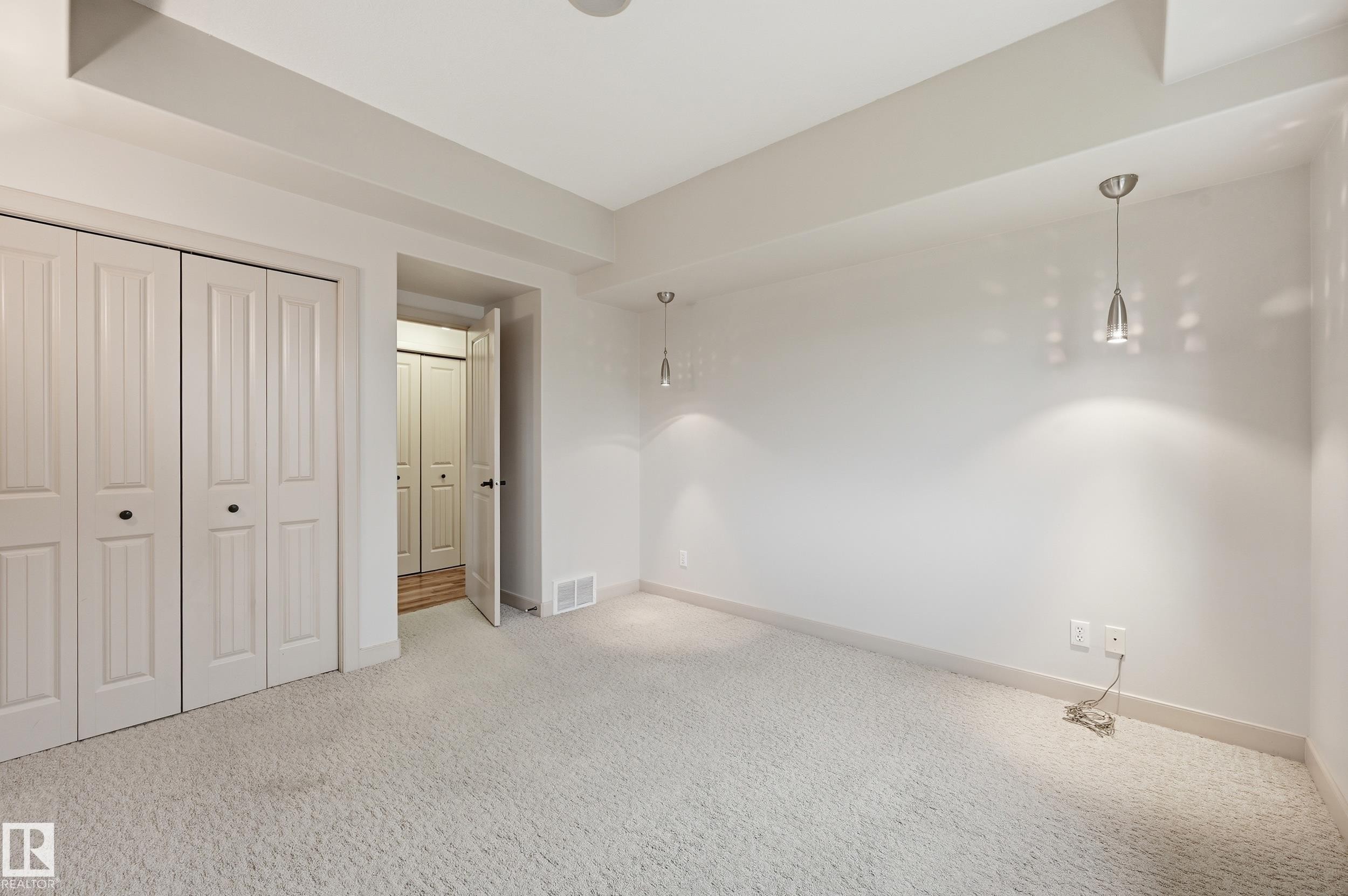 Spacious room featuring light-toned carpeting and neutral wall tones - 50 2565 Hanna Crescent, Edmonton, AB