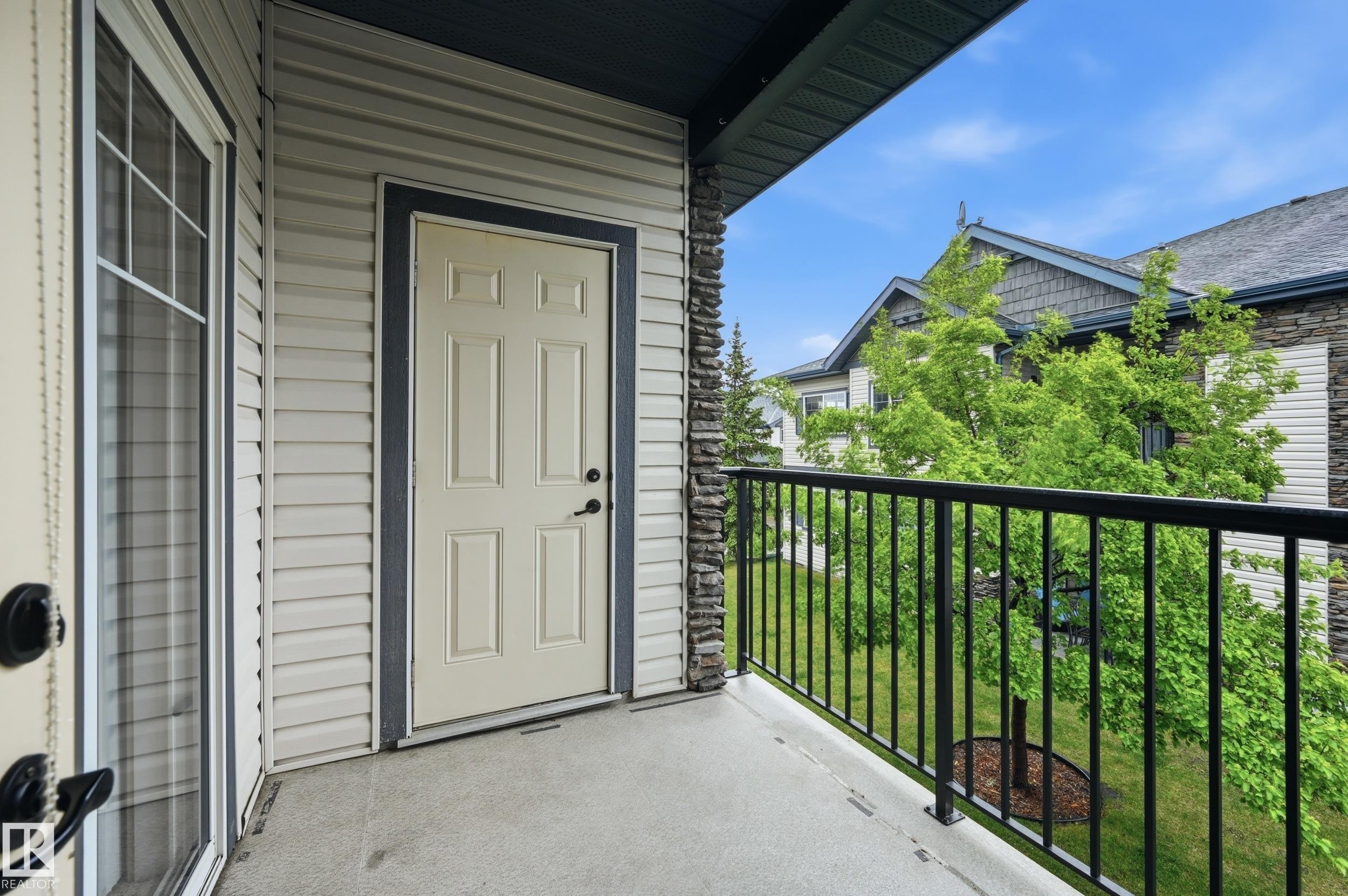 Private balcony featuring a concrete floor, black metal railing, and horizontal siding - 50 2565 Hanna Crescent, Edmonton, AB