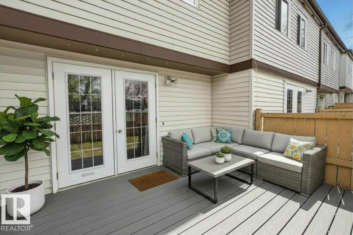 Private outdoor patio featuring gray composite decking - 14648 54 Street, Edmonton, AB