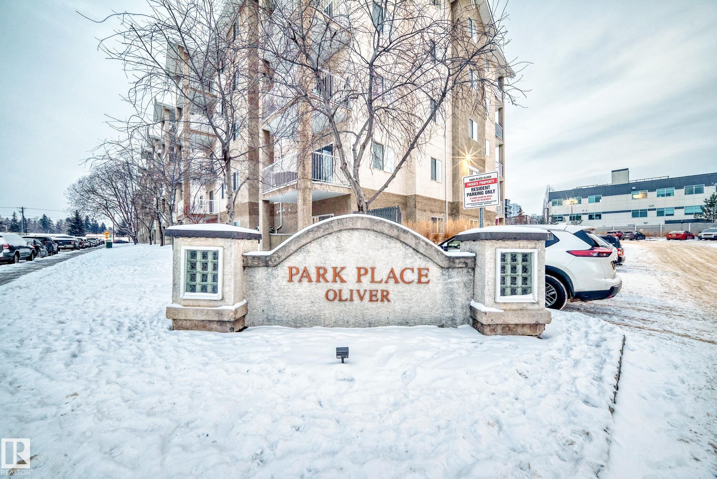 Stone monument signage featuring "PARK PLACE OLIVER" with integrated glass block details - 108 10535 122 Street, Edmonton, AB