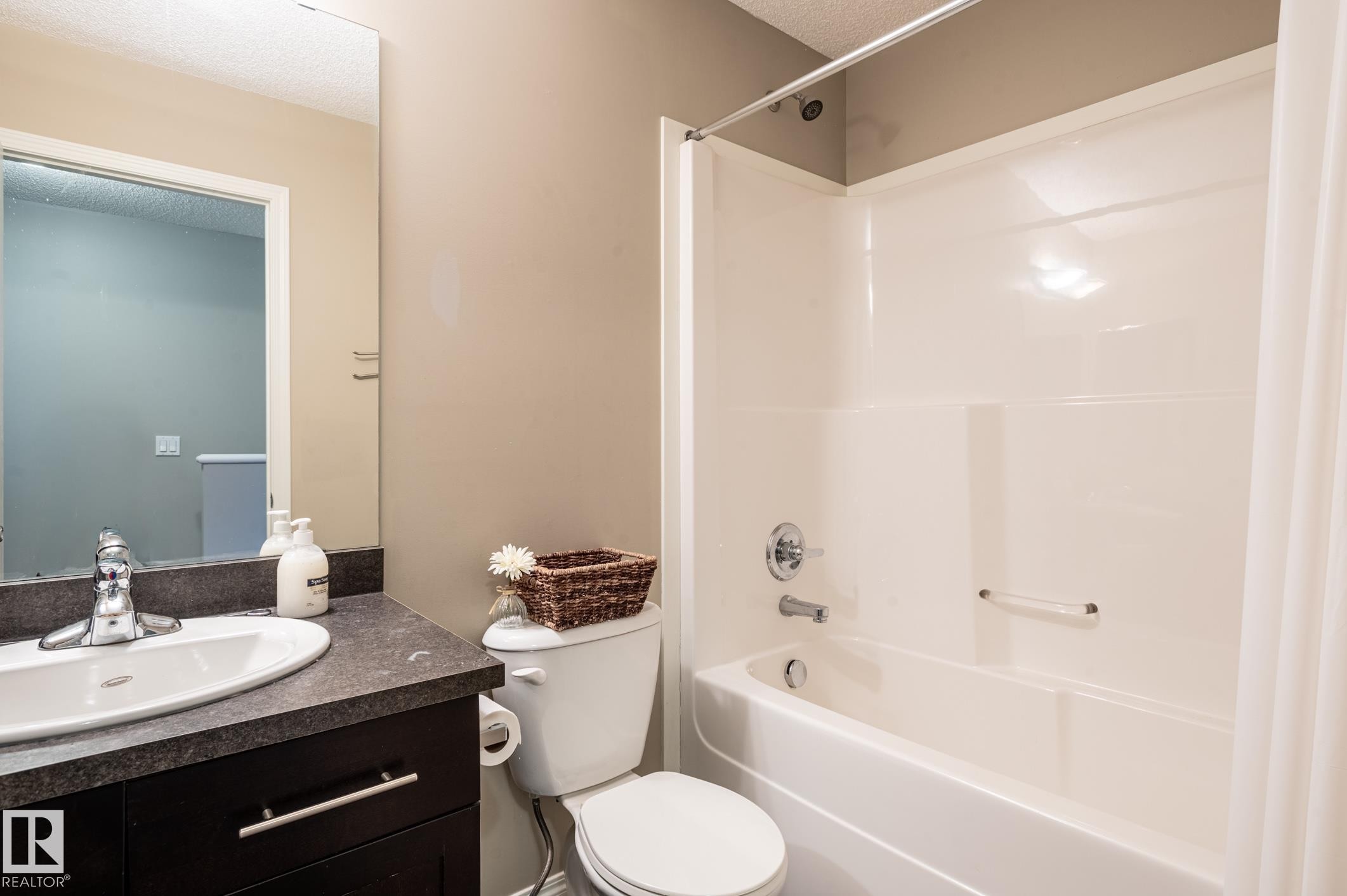 Full bathroom featuring a white tub and shower combination with a curved shower rod - 46 465 Hemingway Road, Edmonton, AB